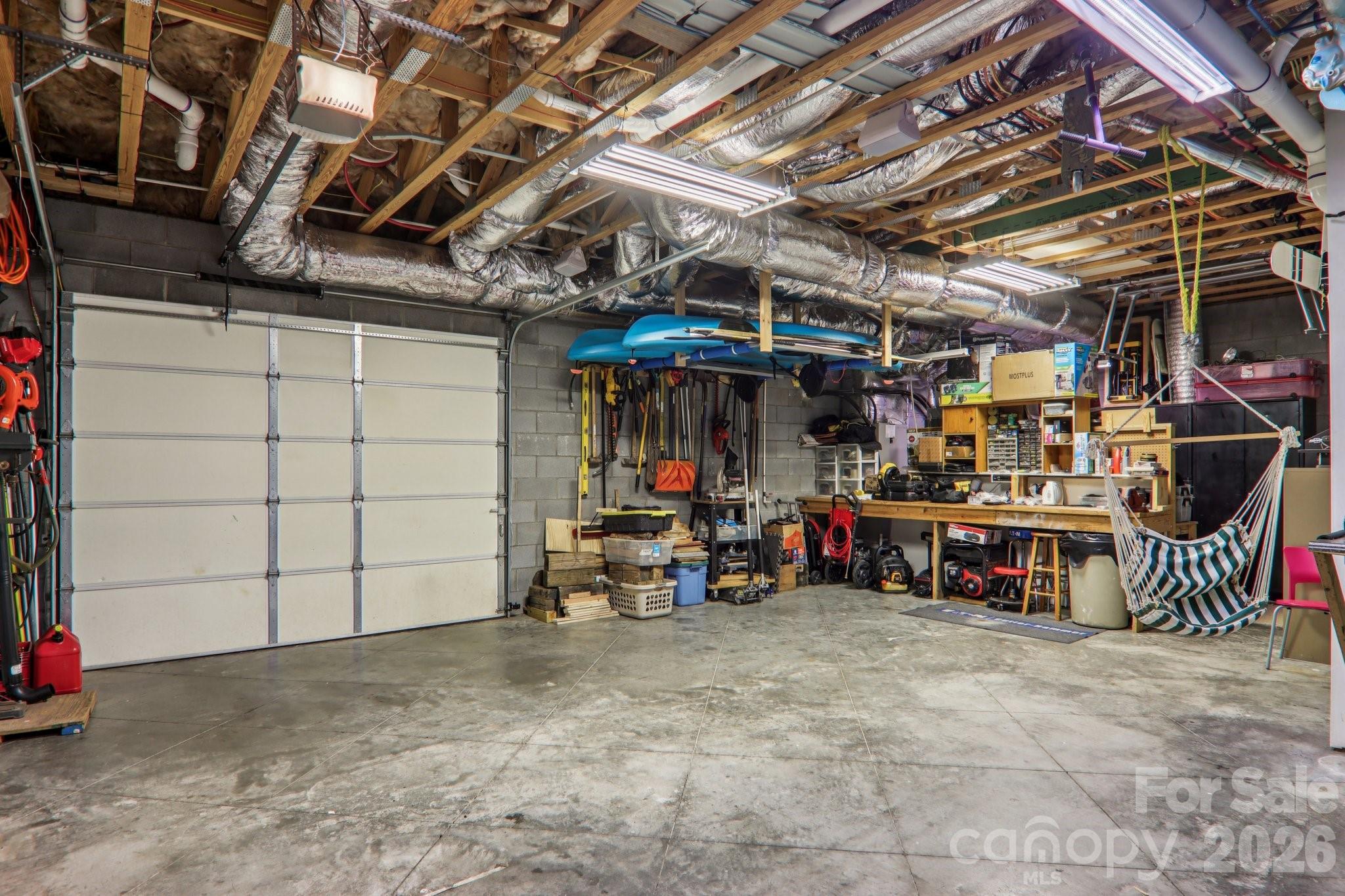 Basement workshop with garage door - 6 Wagon Trace, Flat Rock