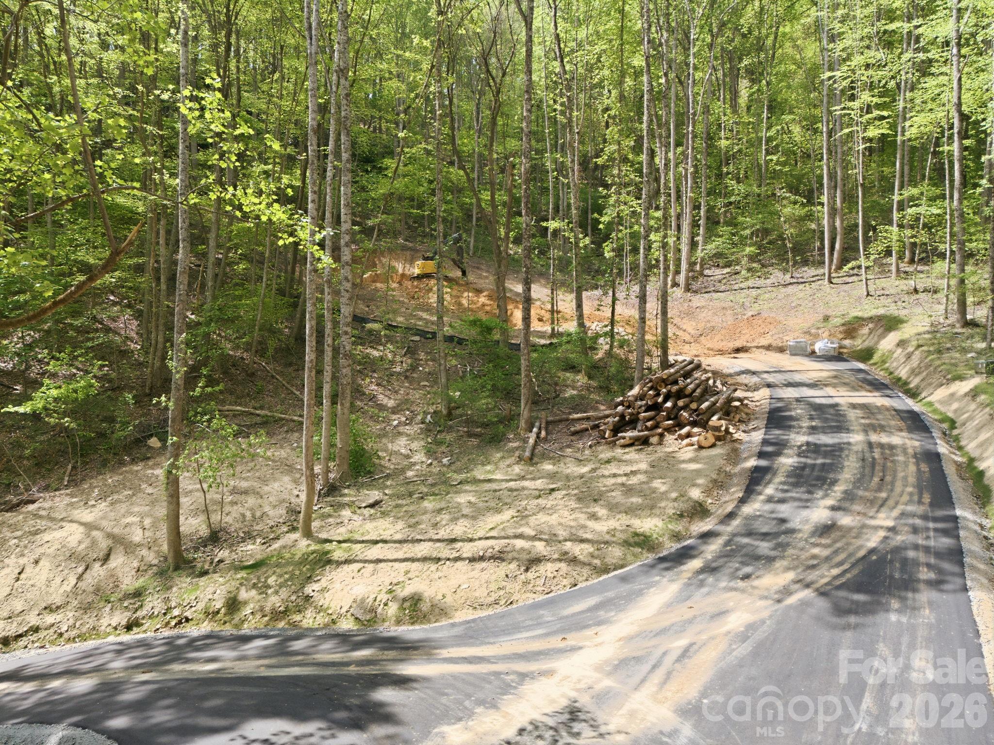Paved drive to the lot; note the excavation of the lot to the center left of the photo. - 122 Running Deer Lane, Mars Hill