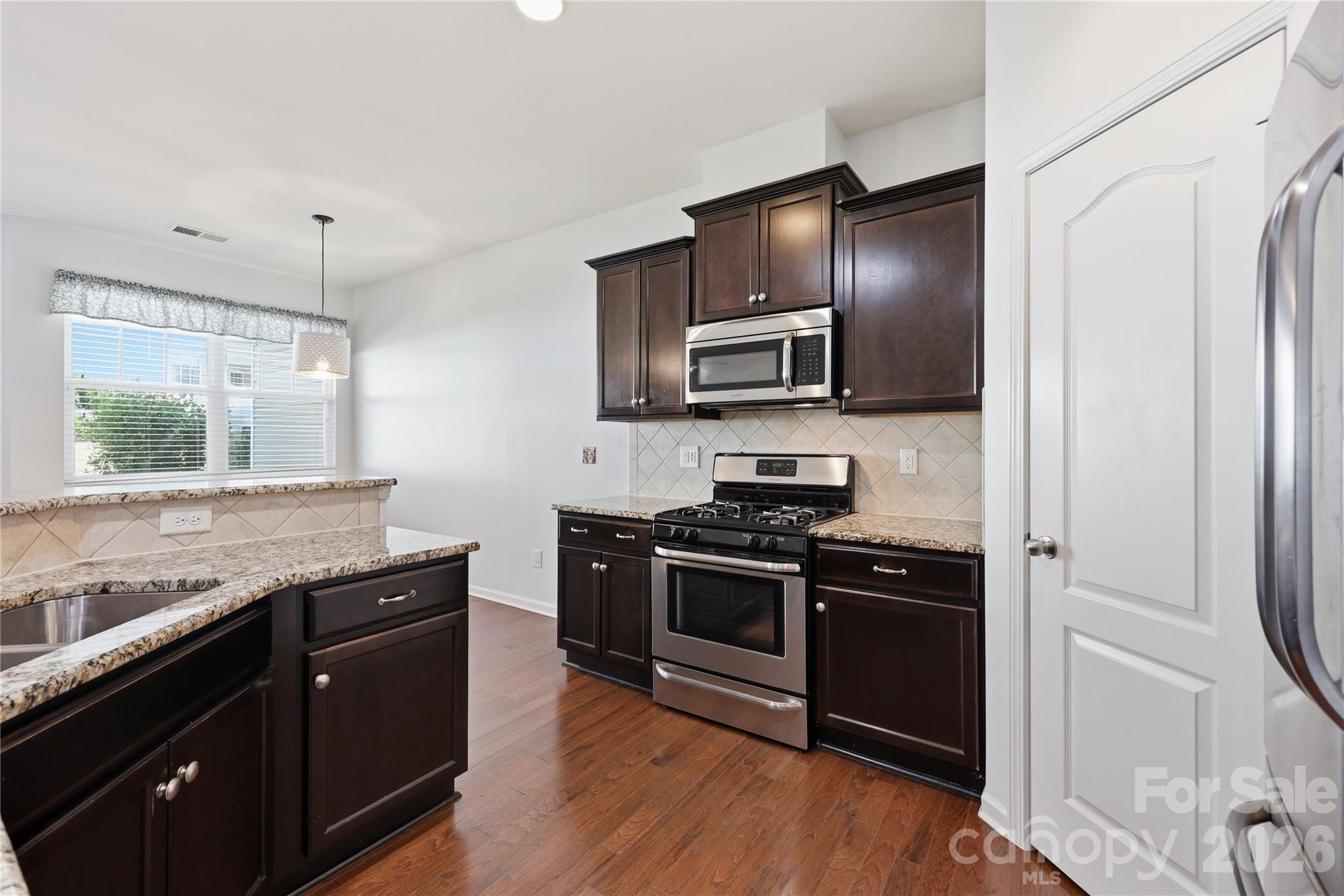 Kitchen with Granite Counters & Stainless Steel Appliances - 7431 Calhoun Falls Drive, Rock Hill