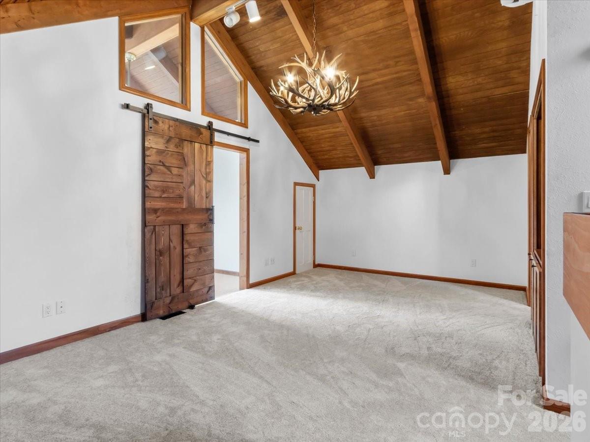 Upper bedroom with new carpet, vaulted ceilings and custom barn door - 49 Slickrock Ridge Way S, Burnsville