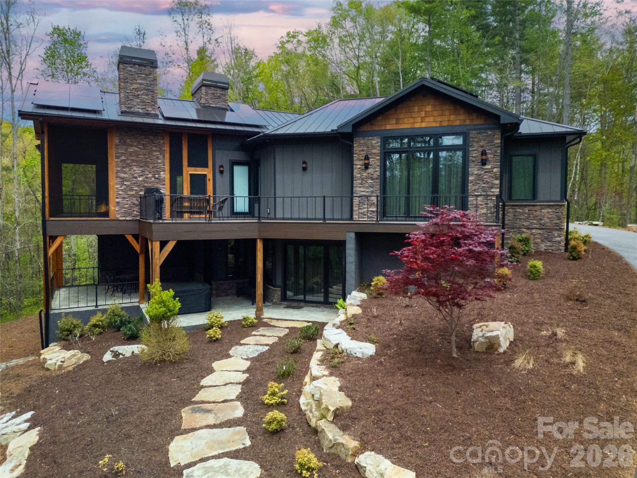 This image captures a side view of the home, specifically highlighting the presence and features of the decks attached to the structure. - 726 Ugugu Drive, Brevard