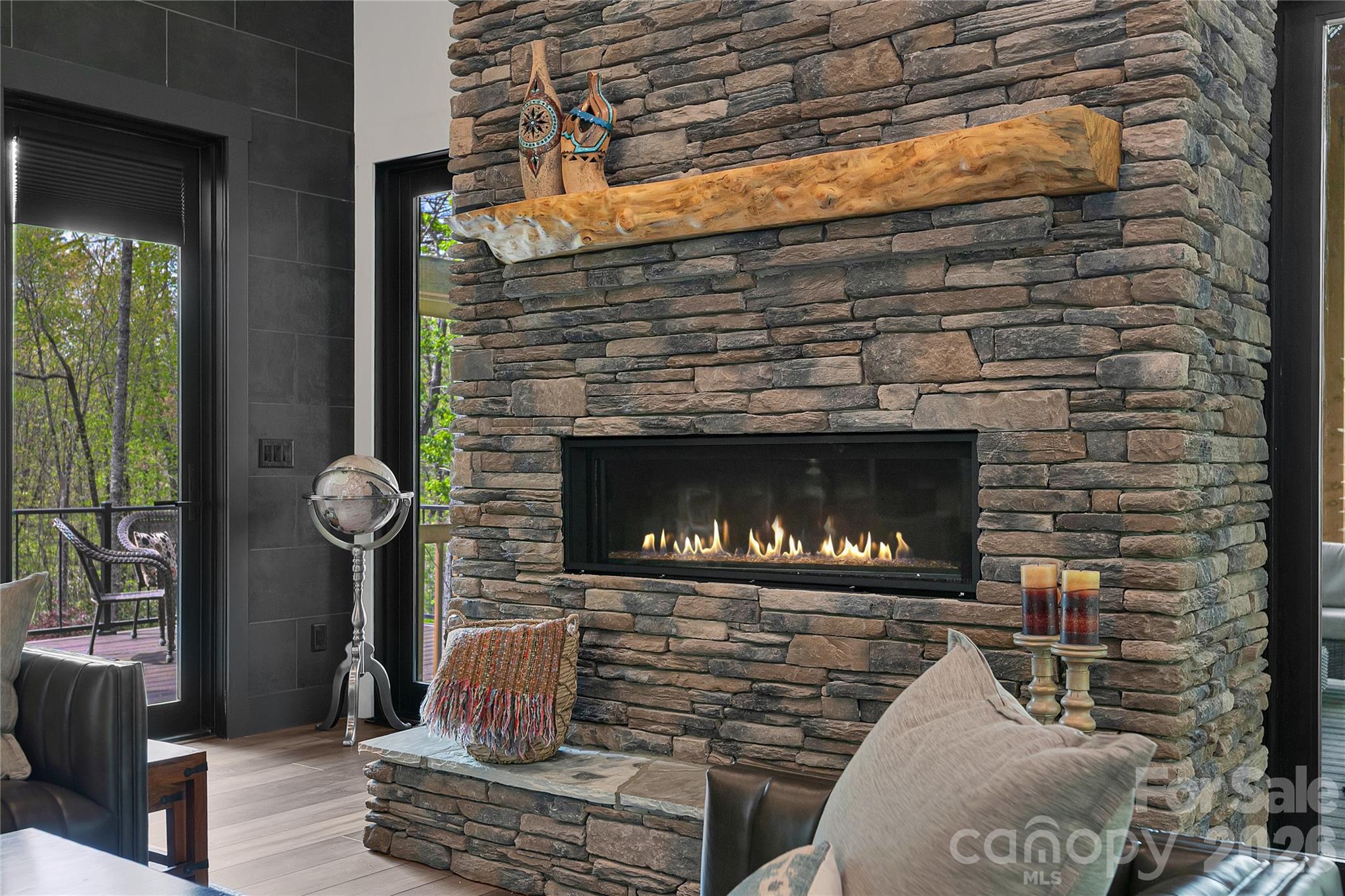 The living room fireplace provides a warm ambiance, suitable for pleasant evenings. - 726 Ugugu Drive, Brevard