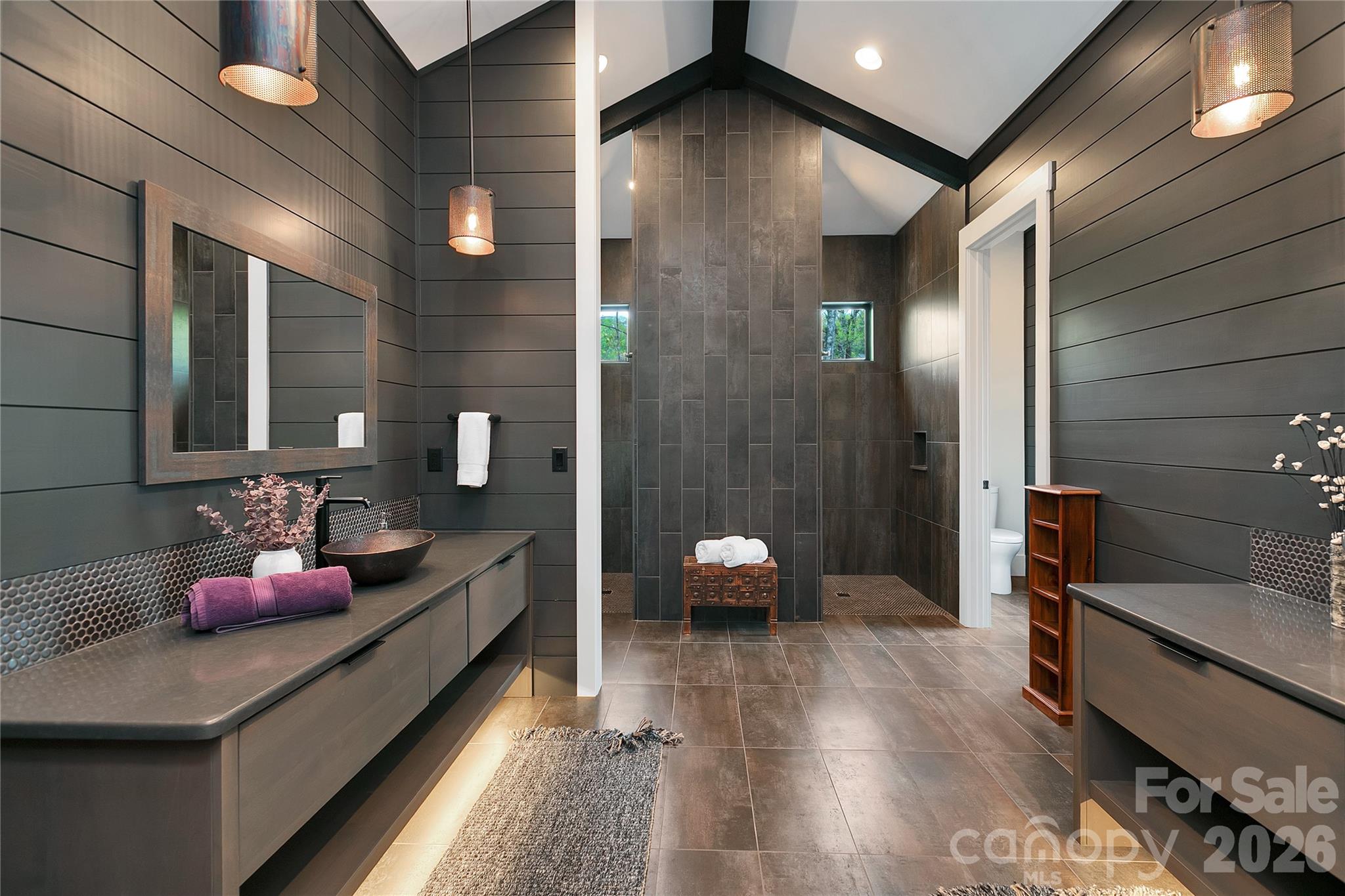 Beautifully appointed , the primary bath showcases dual vanities set on opposite sides offering both elegance and enhanced privacy. - 726 Ugugu Drive, Brevard