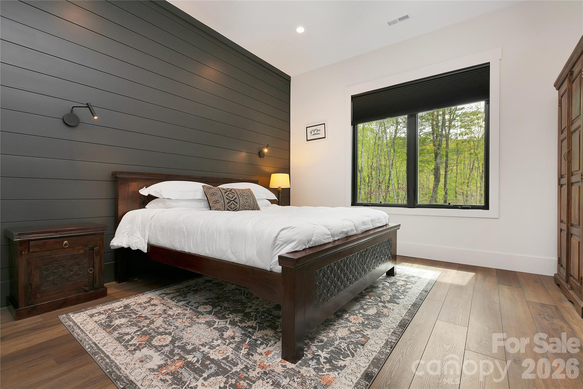 Main level guest bedroom is designed with a private ensuite bath,offering convenience for guest. - 726 Ugugu Drive, Brevard