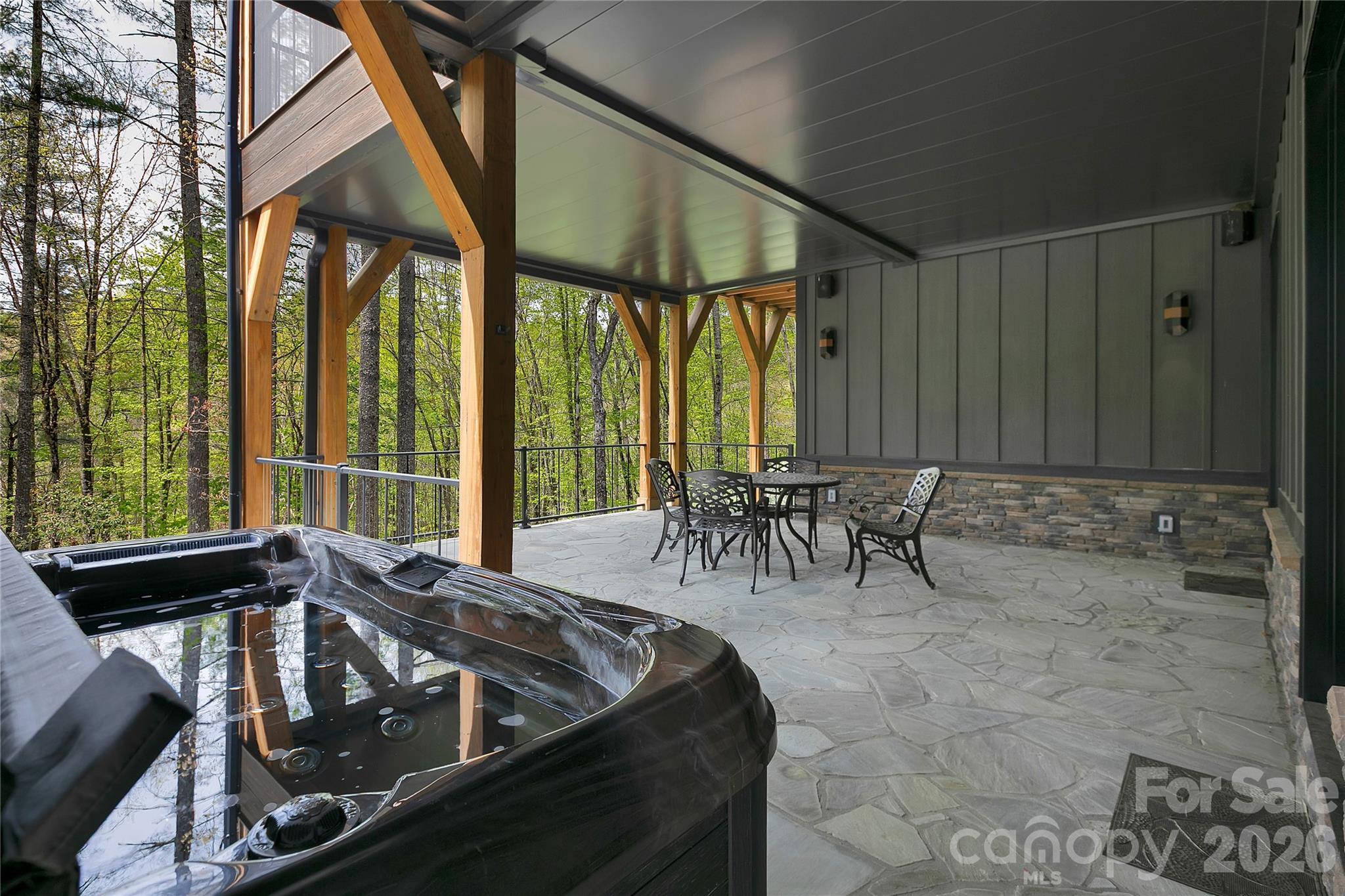 The lower level hot tub and patio space is perfect for unwinding after a day of hiking, pickleball, or any of the many outdoor adventures the area offers. - 726 Ugugu Drive, Brevard