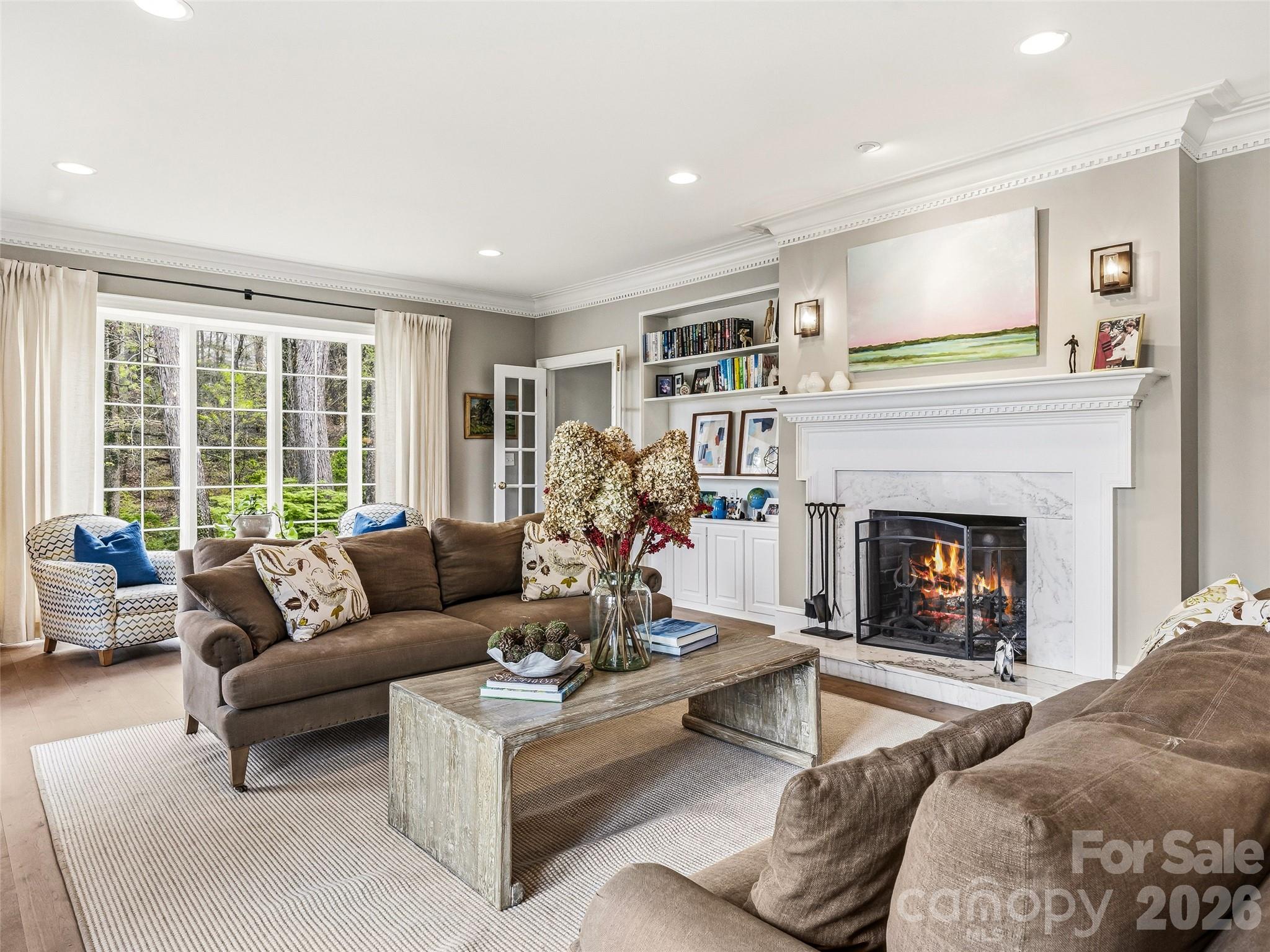 Spacious front living room with built-ins, original windows, and wood burning fireplace. This room opens out to the front terrace. - 10 Kalimar Heights, Hendersonville