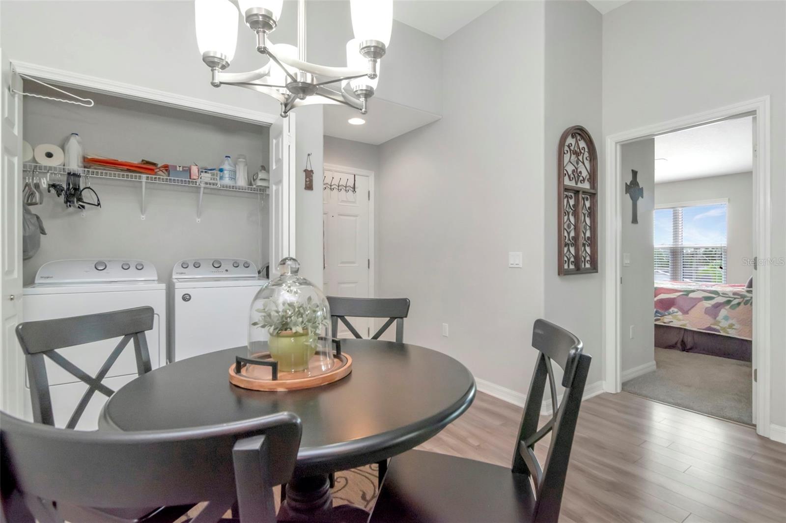 Laundry Closet, dinette and view into Primary Bedroom - 6395 BANYAN BLVD #303, NEW PORT RICHEY