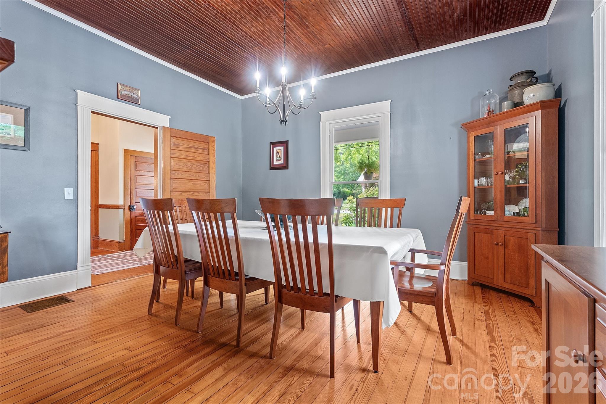 Spacious dining room open to the kitchen with wood bead board ceilings and fireplace. - 602 N Main Street, Davidson