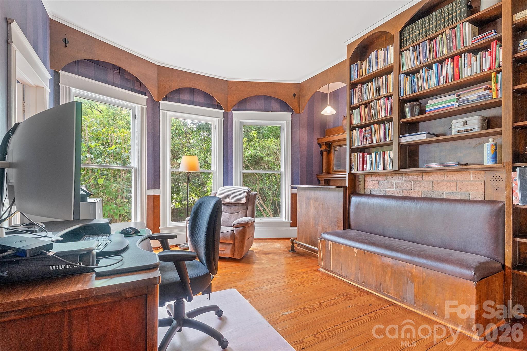 Study connected to primary bedroom with timeless woodworking and built in bench seat, bar and classic mantel. - 602 N Main Street, Davidson