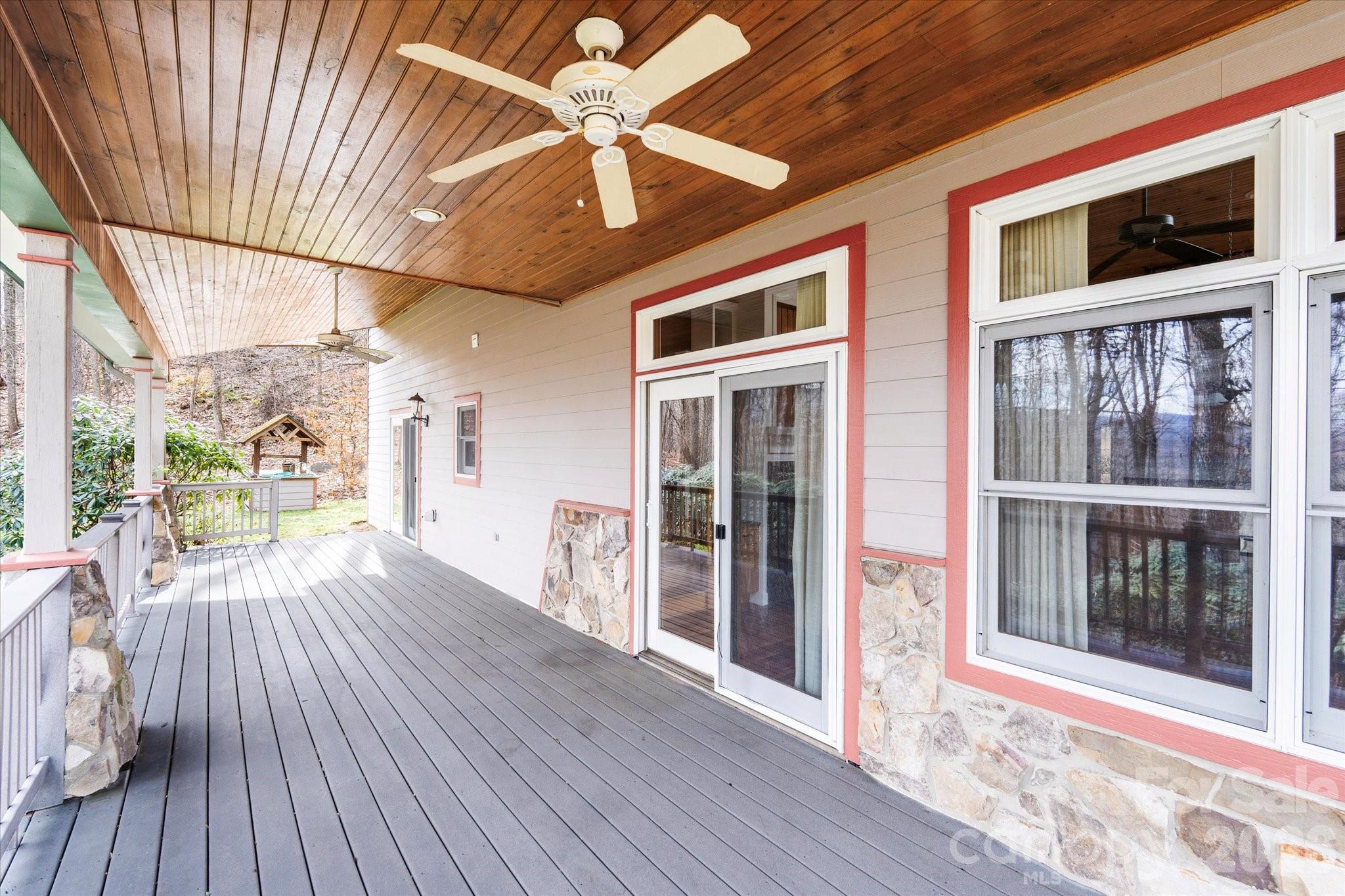 Covered side porch with tongue & groove ceiling and fans to keep cool during the warm months is the perfect place to relax & take in the views. - 905 Old Fiddle Road, Waynesville