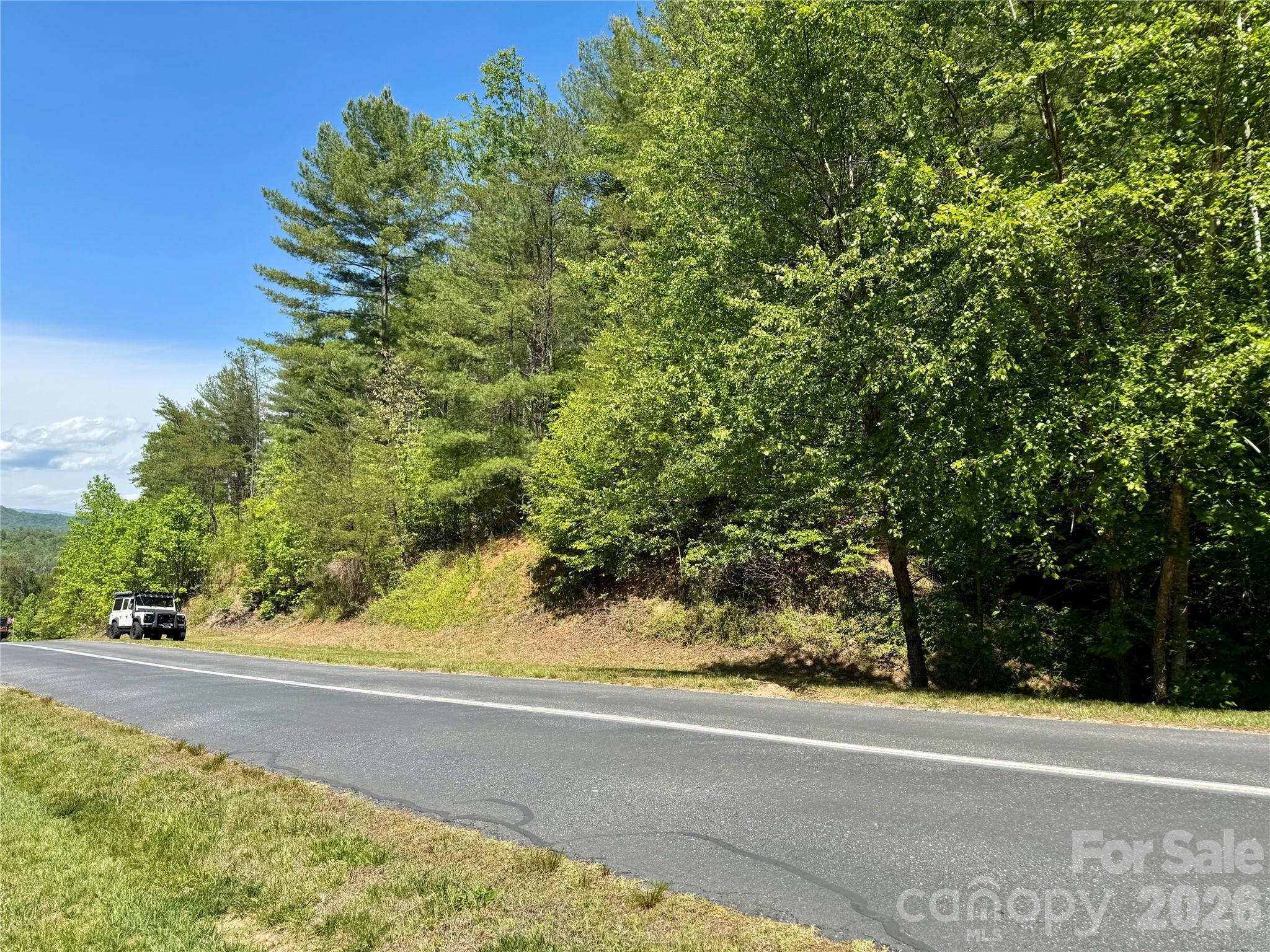 The build site is flat and sits above the street, maintaining privacy. - Lot 104 Johns Ridge Parkway, Lenoir