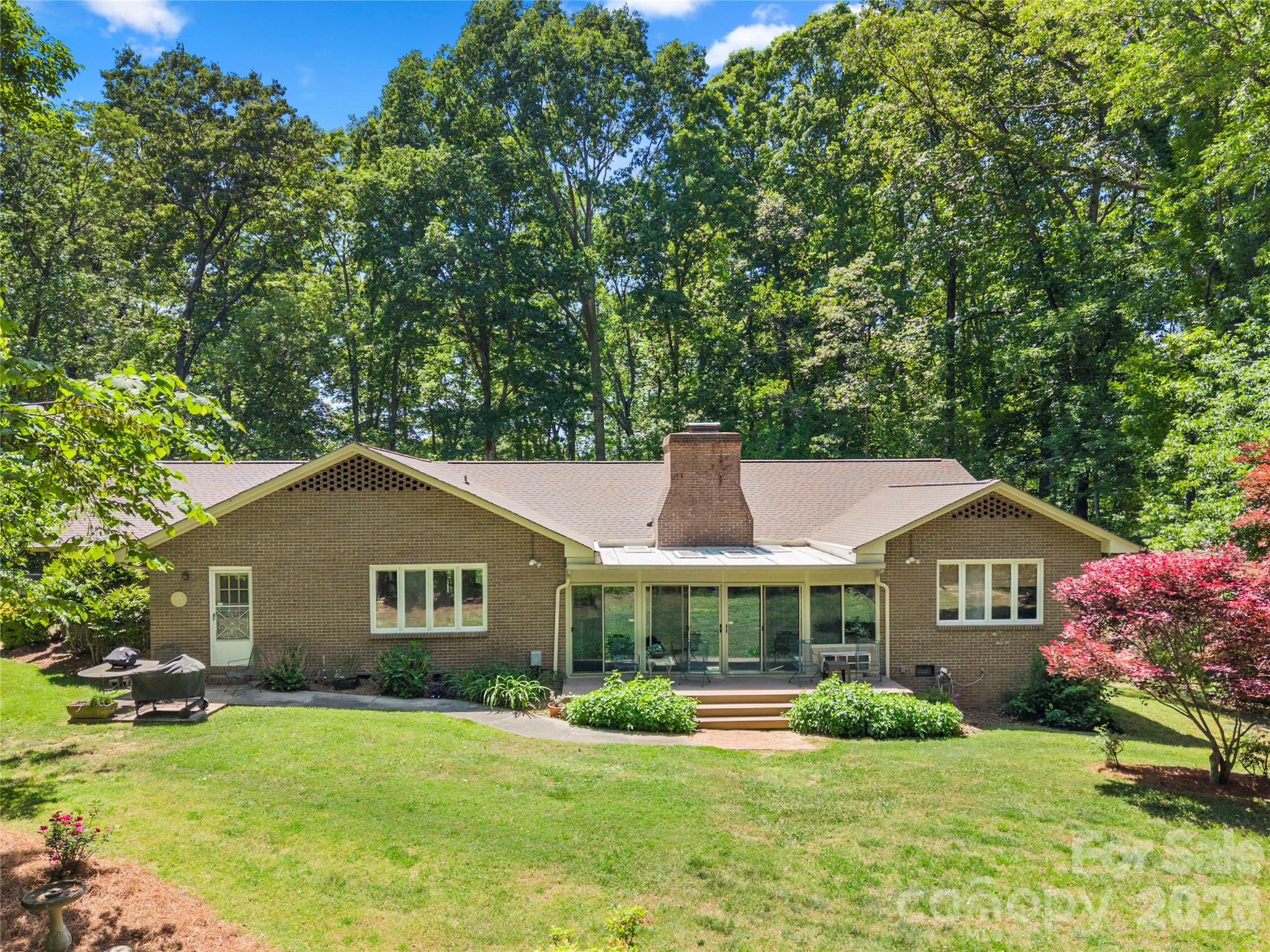Rear of home/backyard - property is completely surrounded by trees - 3426 Driftwood Drive, Gastonia