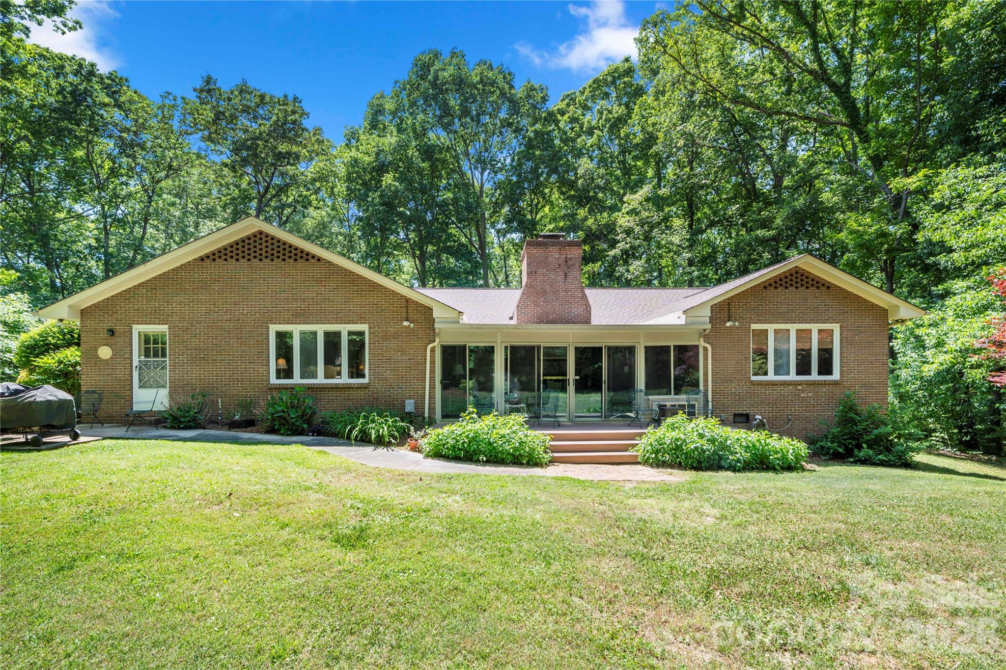 Rear of home completely surrounded by trees - 3426 Driftwood Drive, Gastonia