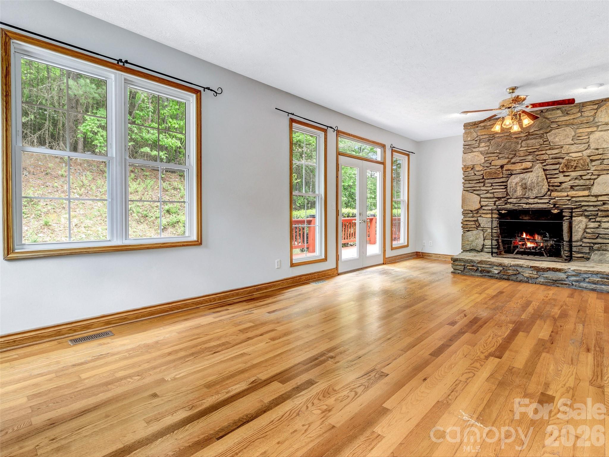 Primary bedroom with stone fireplace. - 287 Shady Creek Lane, Hendersonville