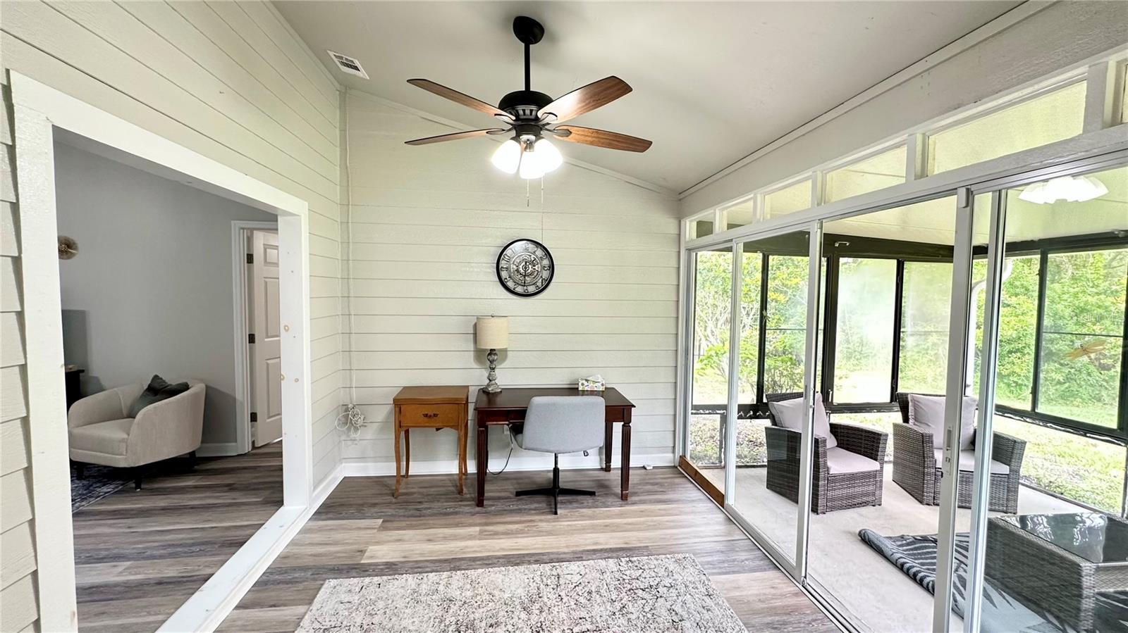 Florida room view from kitchen - 782 PINE SHORES CIR, NEW SMYRNA BEACH