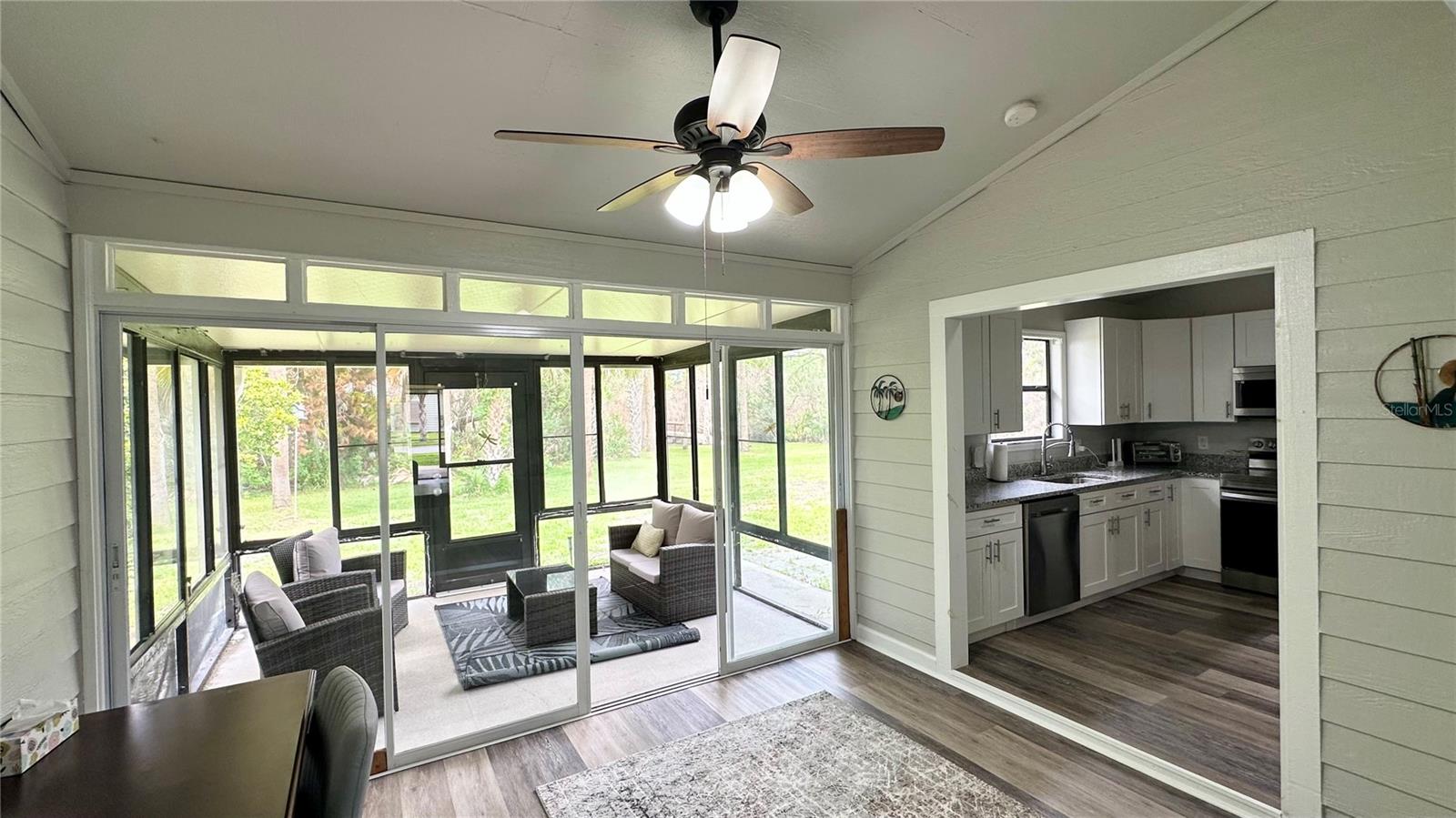 Florida room view from main living area toward back screened porch. - 782 PINE SHORES CIR, NEW SMYRNA BEACH