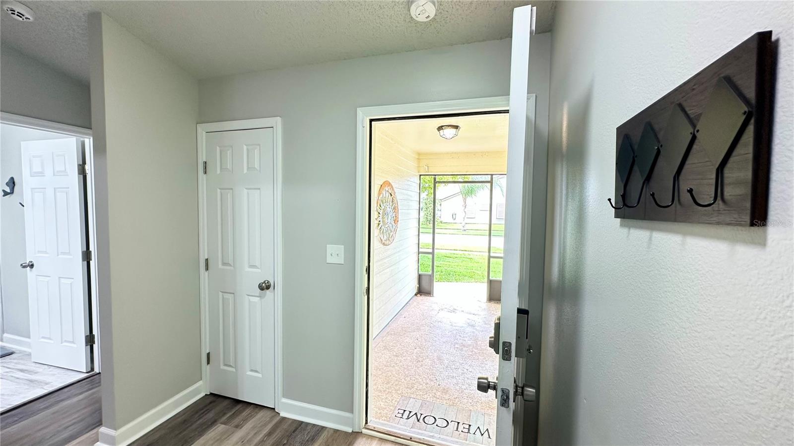 View of front door with guest rooms/bath to left including a privacy wall and hall closet! - 782 PINE SHORES CIR, NEW SMYRNA BEACH