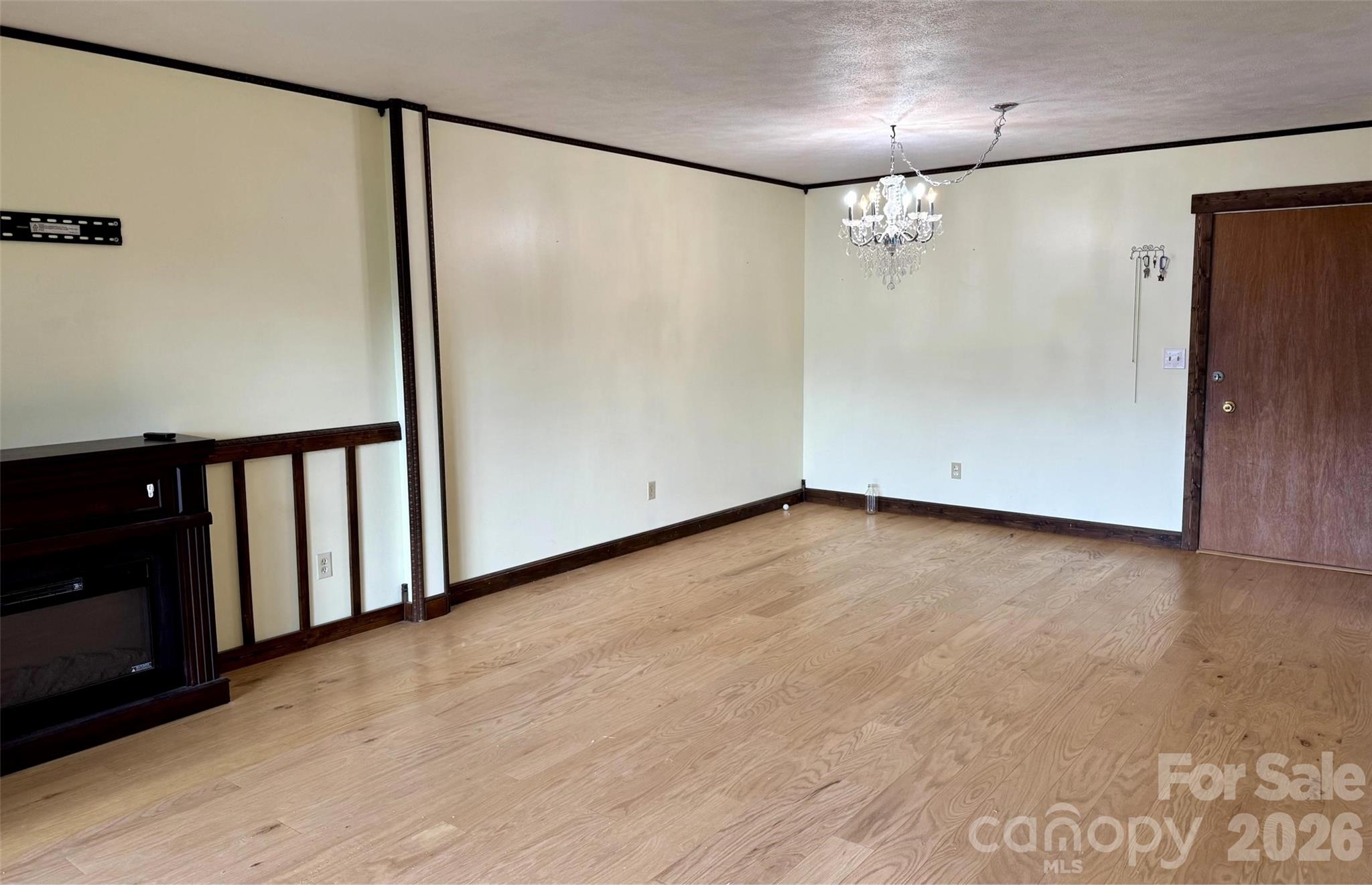 Large living and dining area. Electric fireplace to convey. - 427 6th Avenue W, Hendersonville