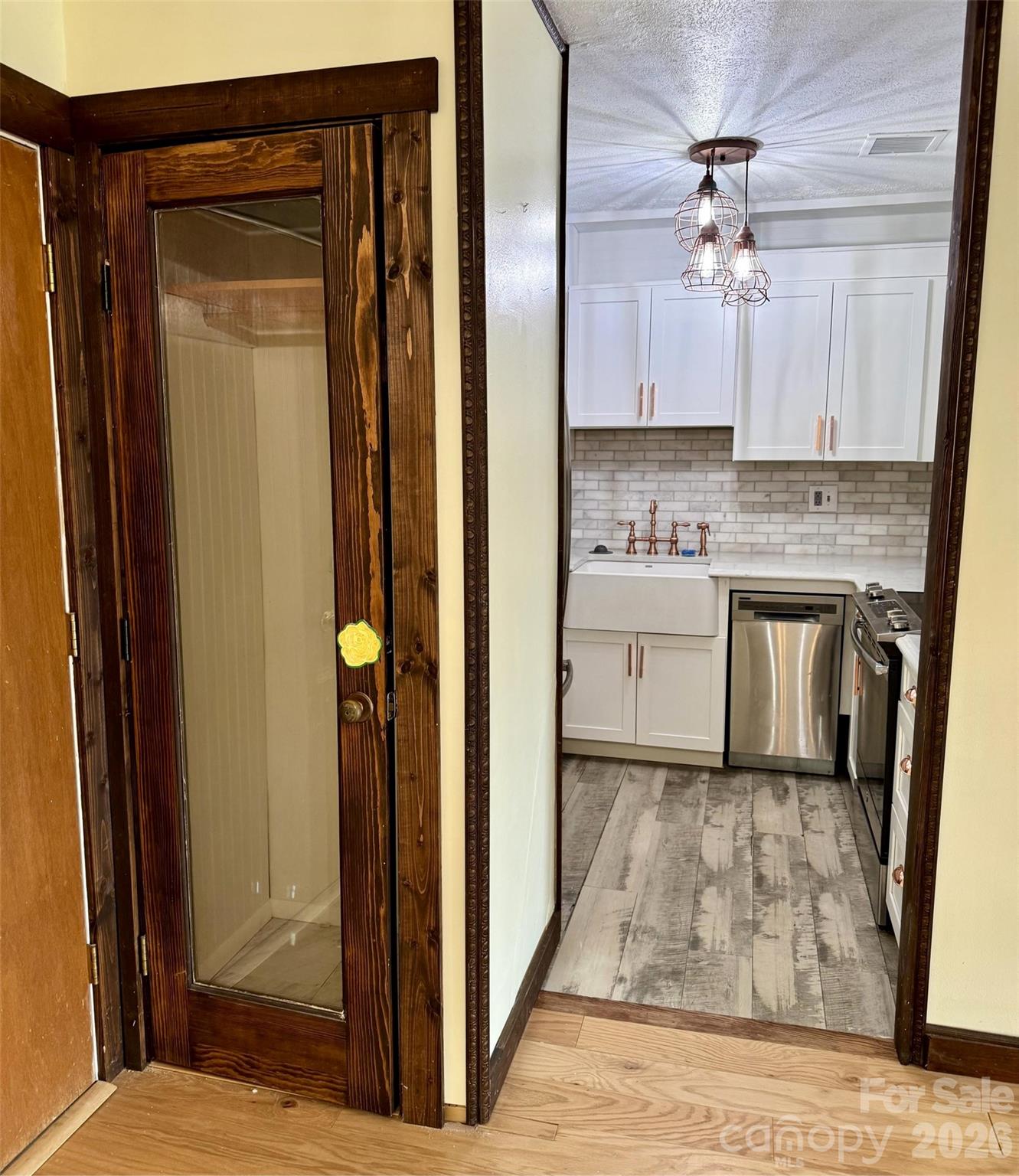 Coat closet, kitchen on right. - 427 6th Avenue W, Hendersonville
