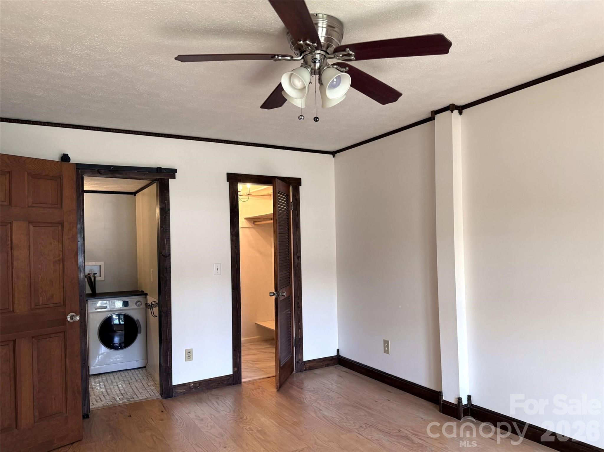 Primary bedroom includes walk-in closet and half-bath with in-unit washer. - 427 6th Avenue W, Hendersonville