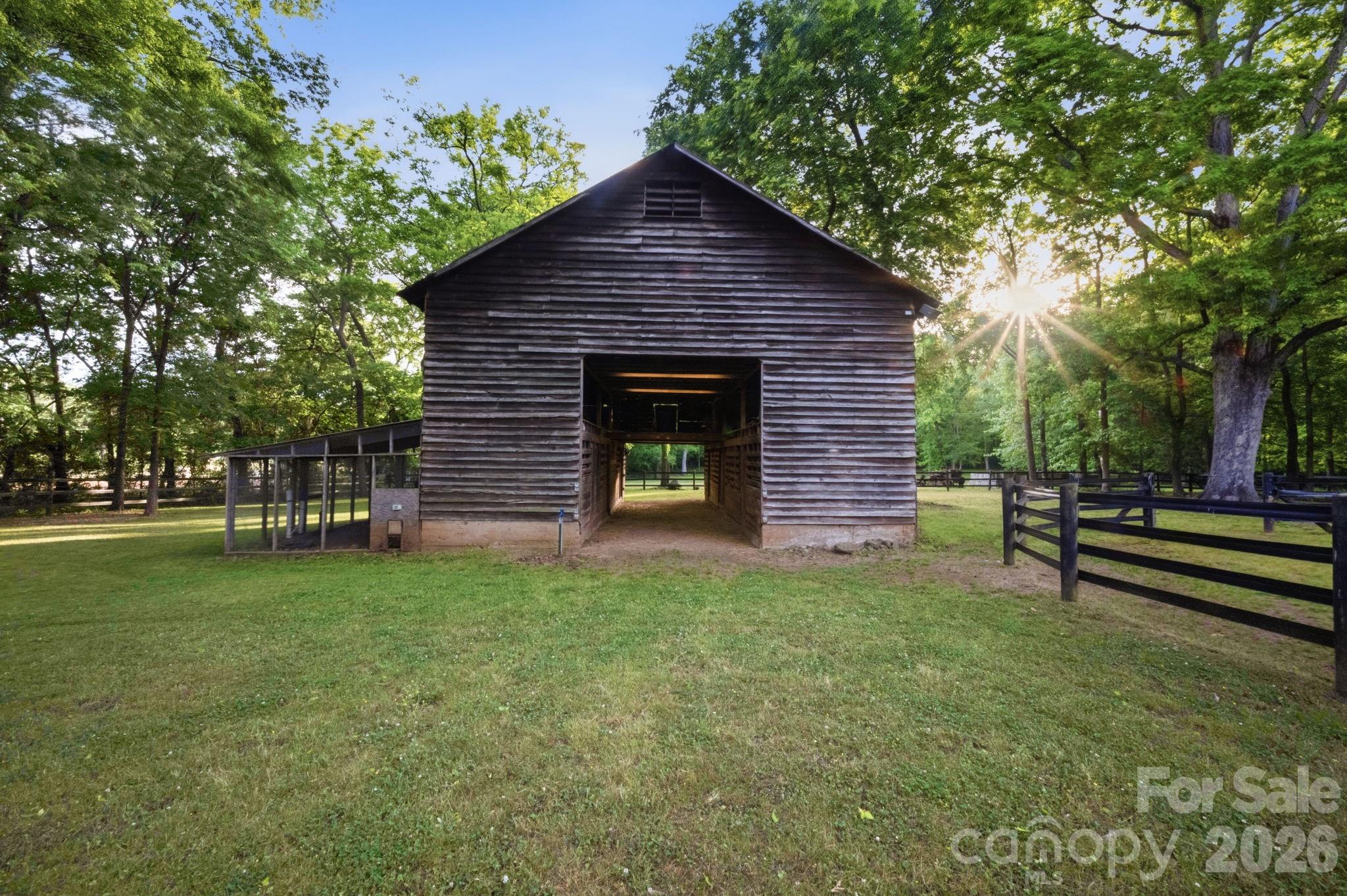 An 8 stall historic barn with an attached chicken coop and hay loft is ideal for your farm animals of choice making this an ideal sustainable hobby farm. - 10915 Beatties Ford Road, Huntersville
