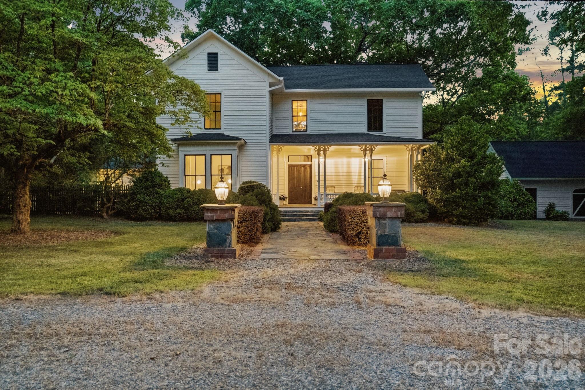 Stone and brick columns greet you at the circular driveway with a brick walk way to the front porch. - 10915 Beatties Ford Road, Huntersville