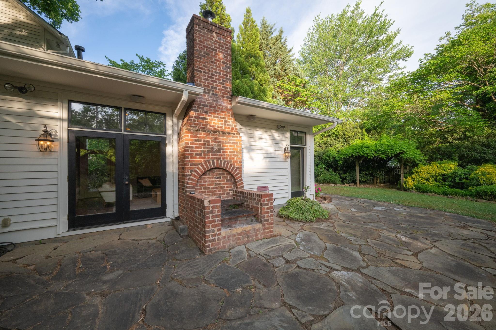 Built-in brick grill uses wood or charcoal.  Doors open to great room - 10915 Beatties Ford Road, Huntersville