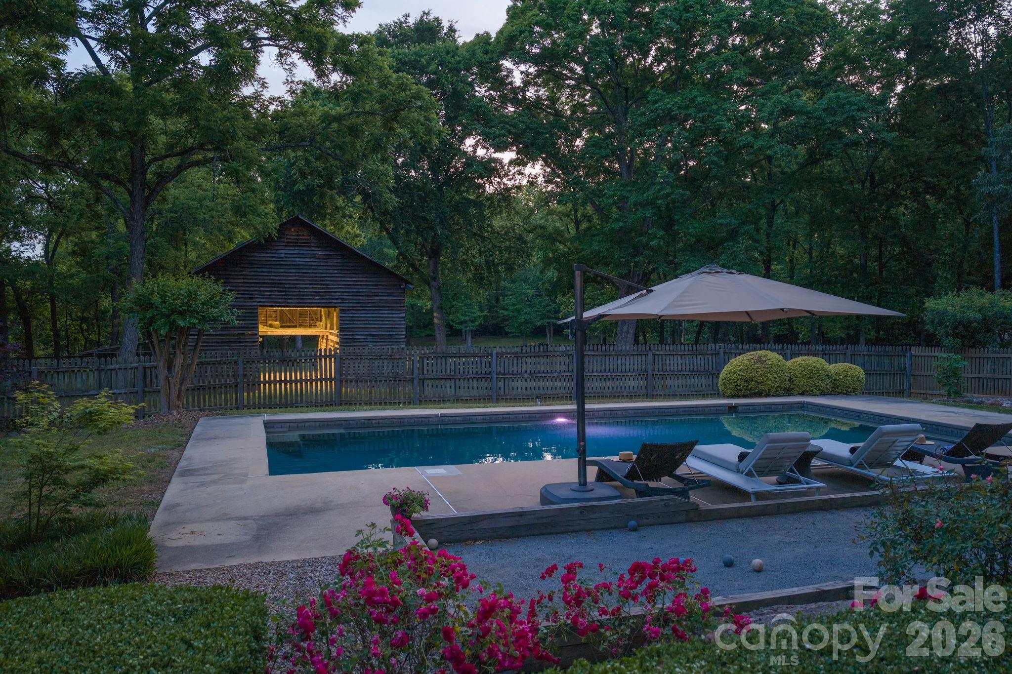 Bocce Ball Court, salt water pool with pebble sheen finish and built-in ledges.  Gardens surround the yard and house and all created by a master gardener - 10915 Beatties Ford Road, Huntersville