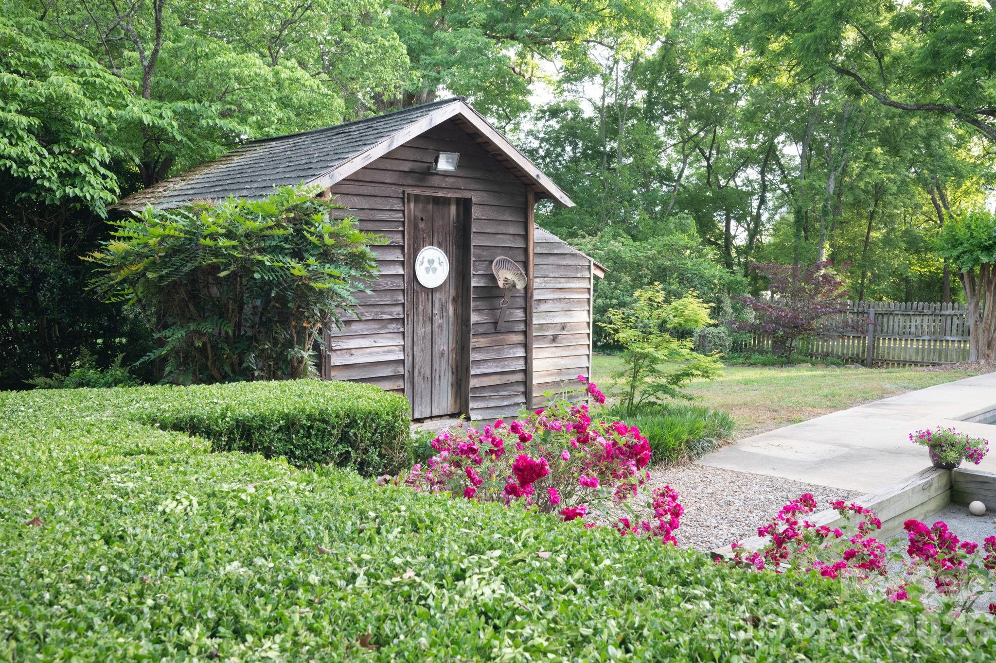 Original tack house used as storage and pool equipment.  Landscaping includes blueberry and blackberry bushes, fig and mulberry trees and several varieties of roses. - 10915 Beatties Ford Road, Huntersville