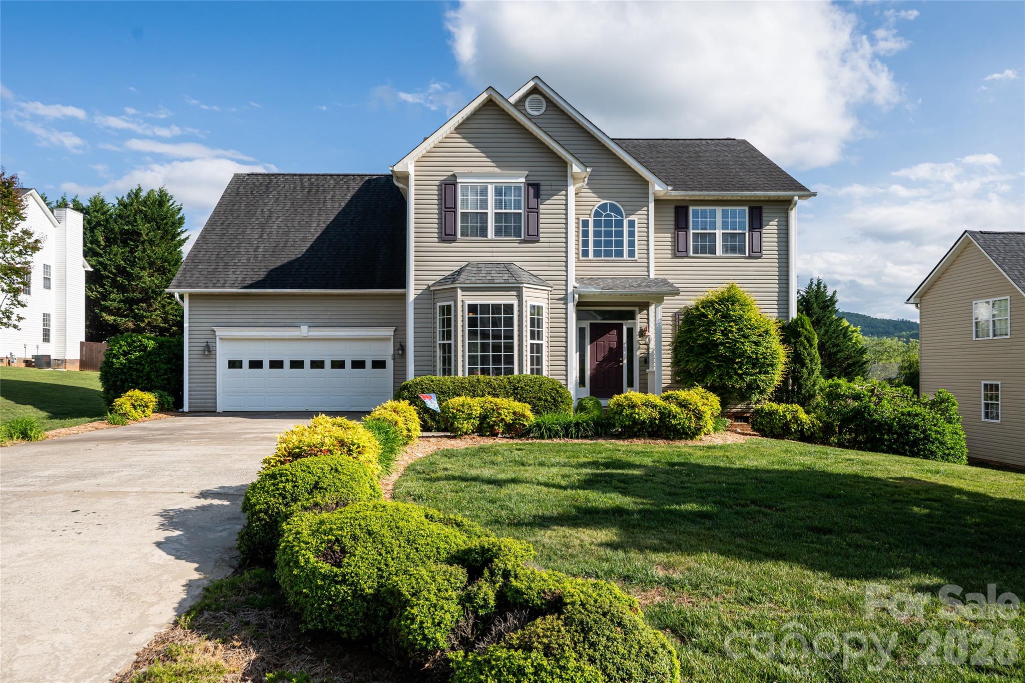 Front elevation of 48 Brownstone Court, Fletcher: traditional two-story built 2002, attached two-car garage, concrete driveway, architectural shingle roof, level cul-de-sac lot in Livingston Farms. - 48 Brownstone Court, Fletcher