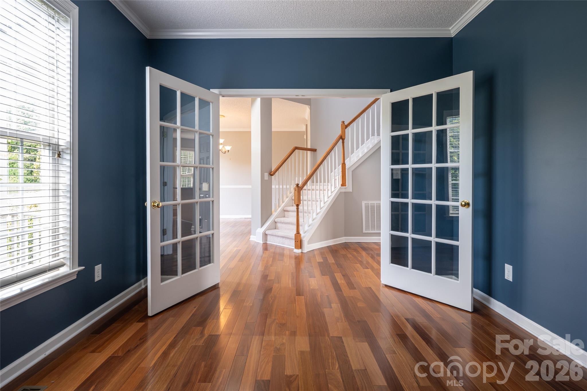 French-door front room as-is, looking through to the two-story foyer and staircase. - 48 Brownstone Court, Fletcher