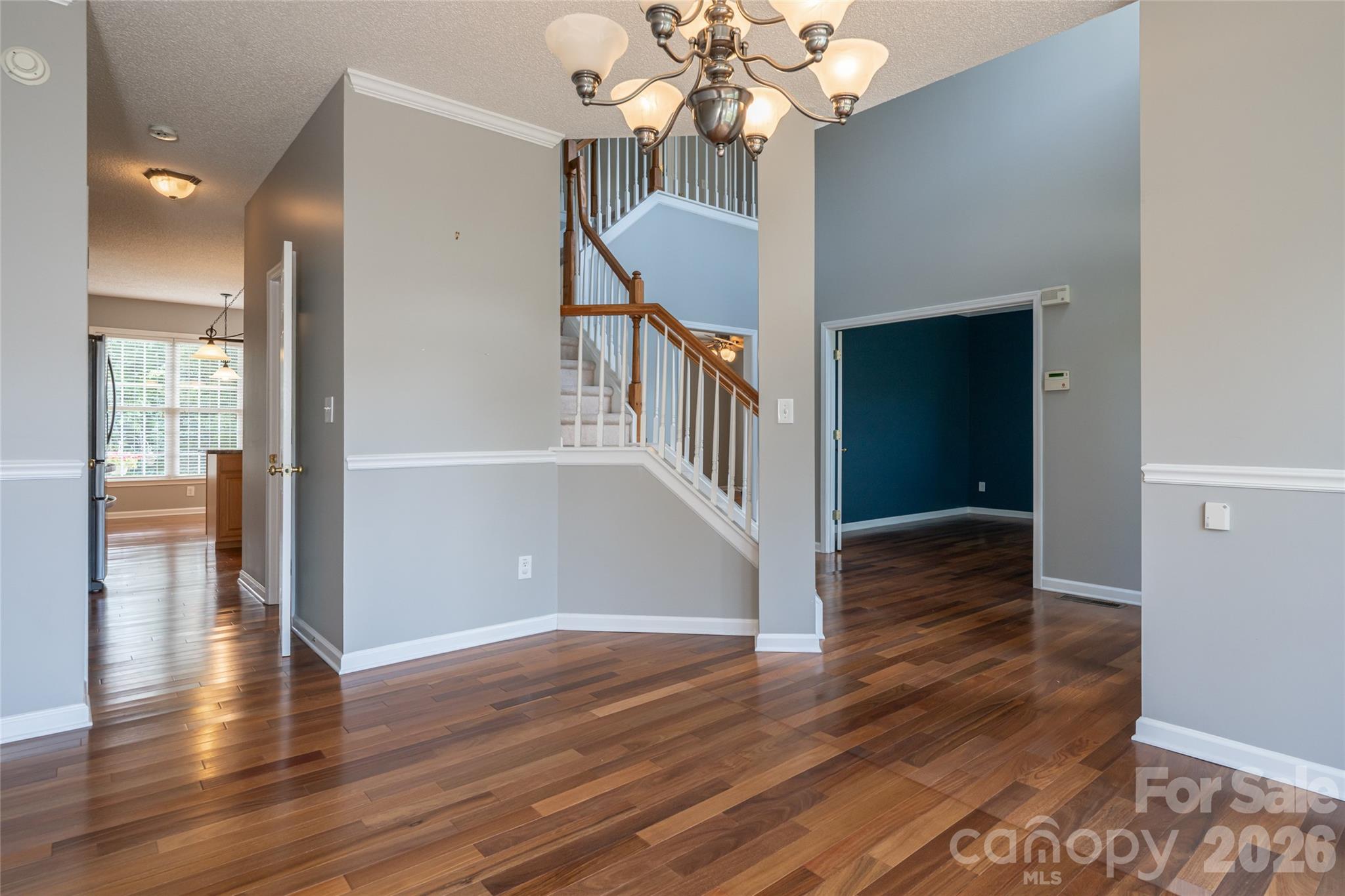 Two-story foyer with accent wall, open staircase and upstairs landing; main level flows to formal dining, kitchen and family room. - 48 Brownstone Court, Fletcher