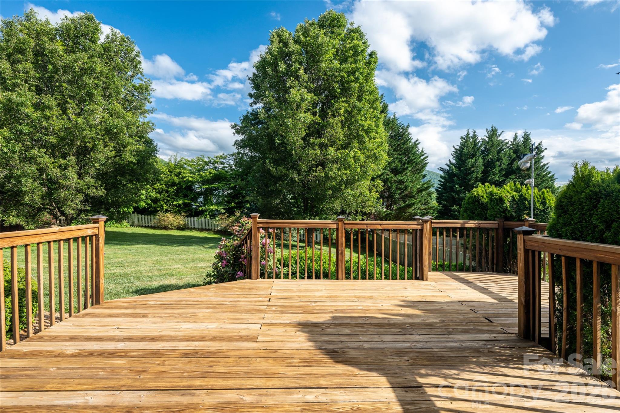 Rear deck as-is, looking over the backyard toward the tree line and green space border. - 48 Brownstone Court, Fletcher