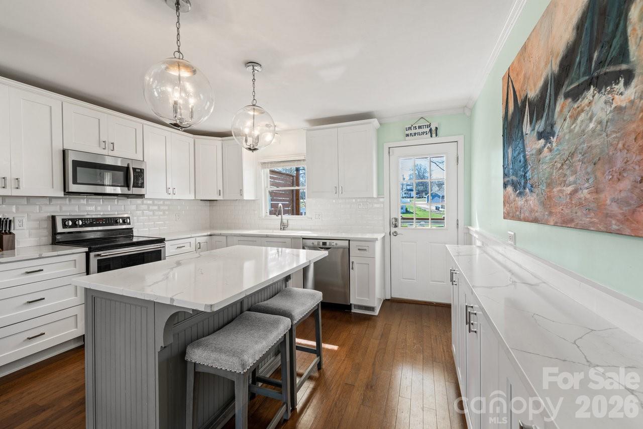 Updated white kitchen with an abundance of cabinets and storage - 141 Bluewing Lane, Mooresville