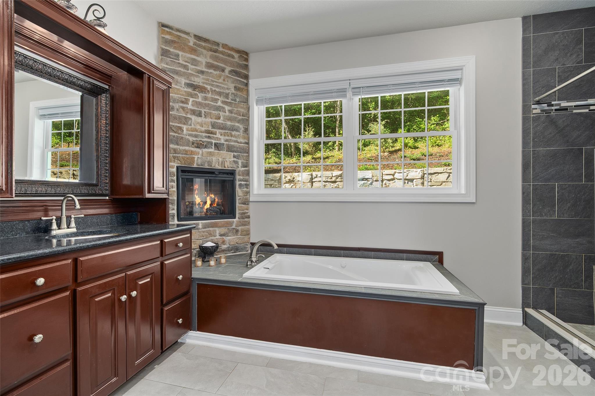 Primary ensuite bath with soaking tub with electric fireplace - 114 Nesting Ridge, Waynesville