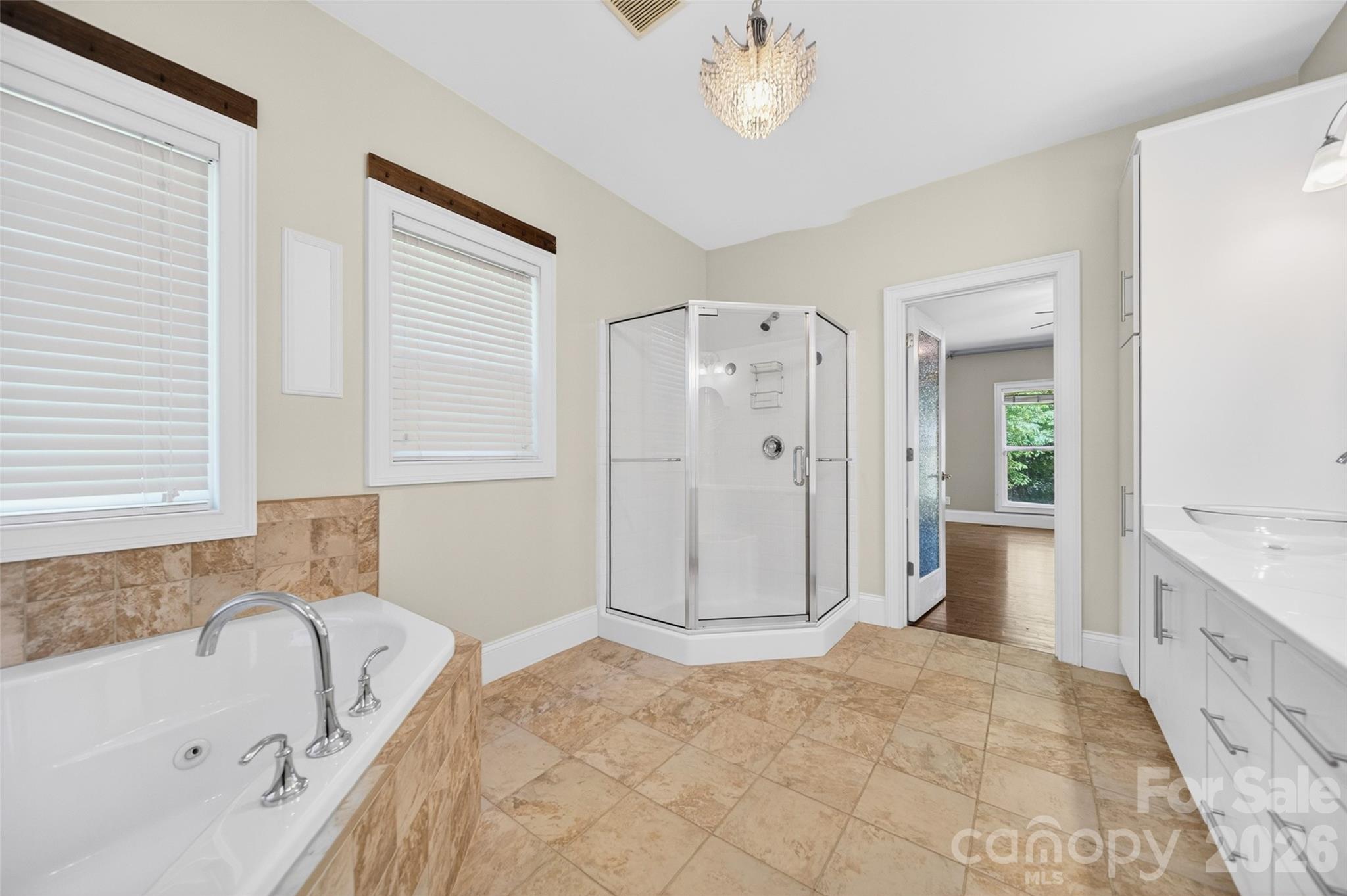 Primary offers a private en suite bathroom providing exclusive access, long wall dual vanities with vessel sinks and deep drawer storage. - 2977 Cabin Creek Drive, Catawba
