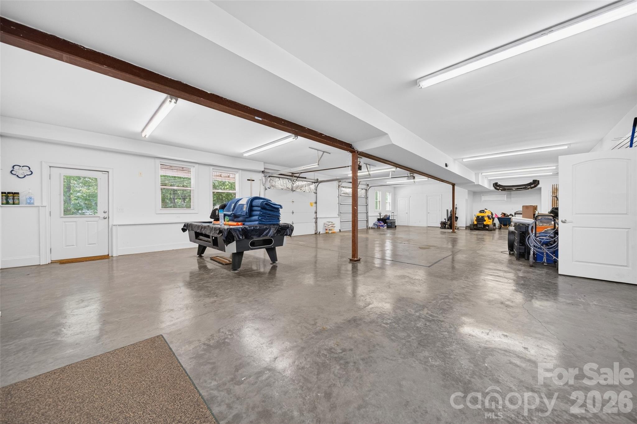 THIS!! Basement offers more than we can list. Finished walls, polished concrete floors, Two entry garage doors, natural light, laundry, multiple storage areas, work shops AND a Full bathroom with walk-in shower. Pool Table conveys! - 2977 Cabin Creek Drive, Catawba