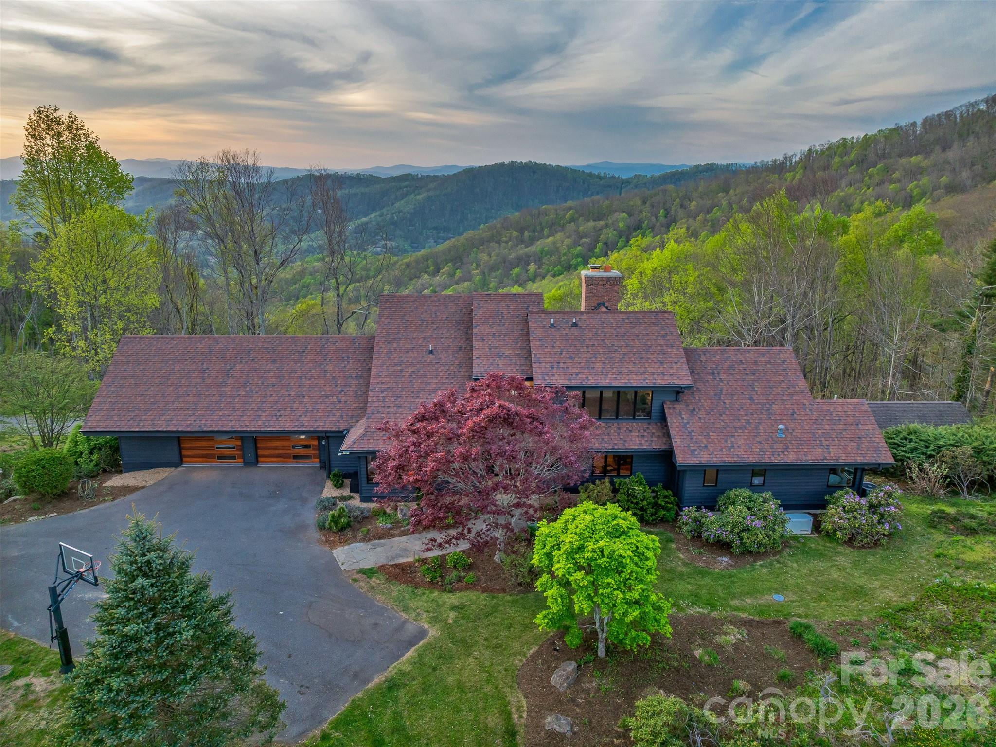Thoughtful landscape design features native Rhododendron, Japanese maples, flowering cherry trees, hydrangeas and more. - 100 Big Spring Drive, Asheville