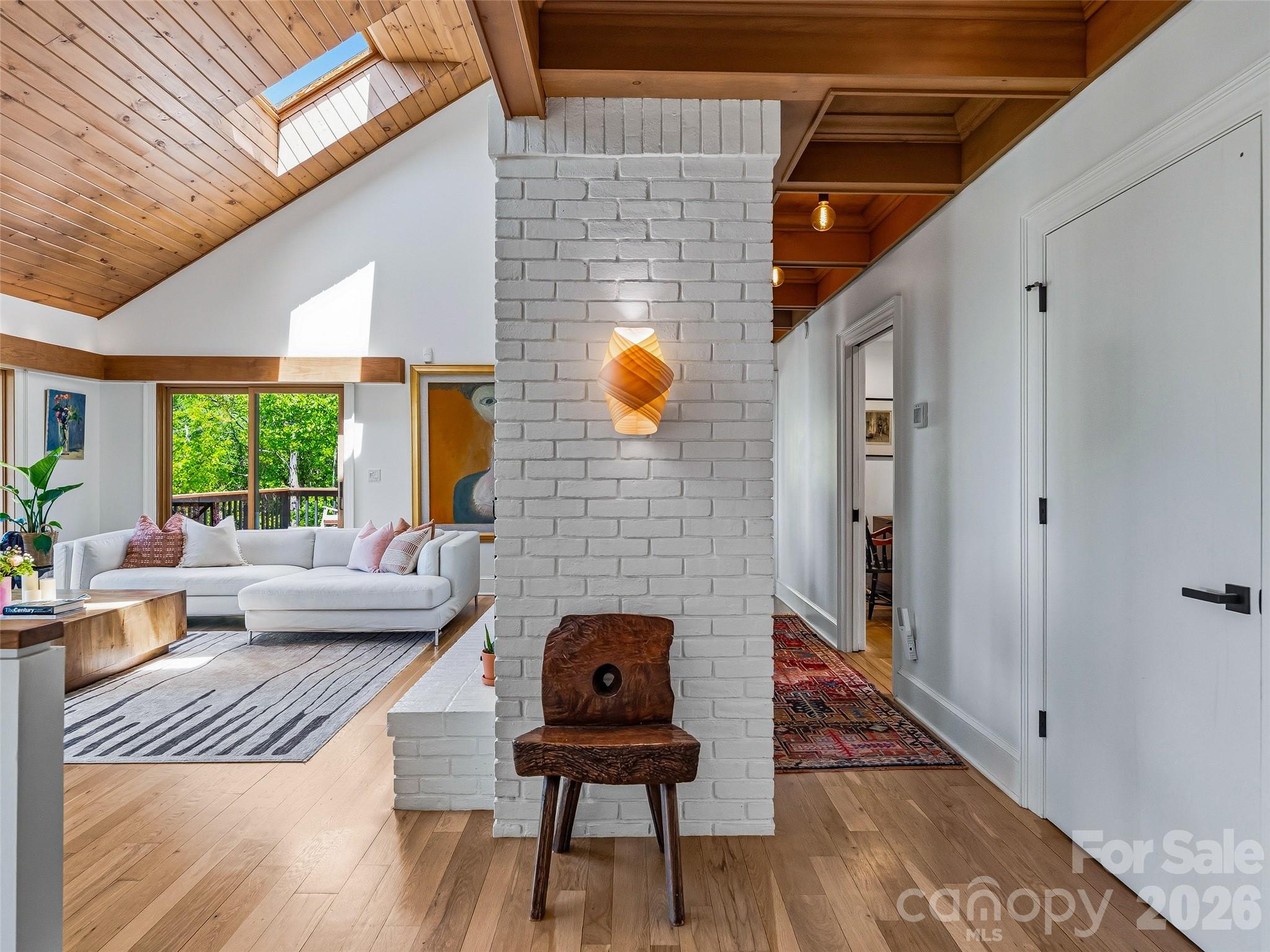 The foyer leads to a  spacious yet cozygreat room with vaulted knotty pine ceilings. - 100 Big Spring Drive, Asheville