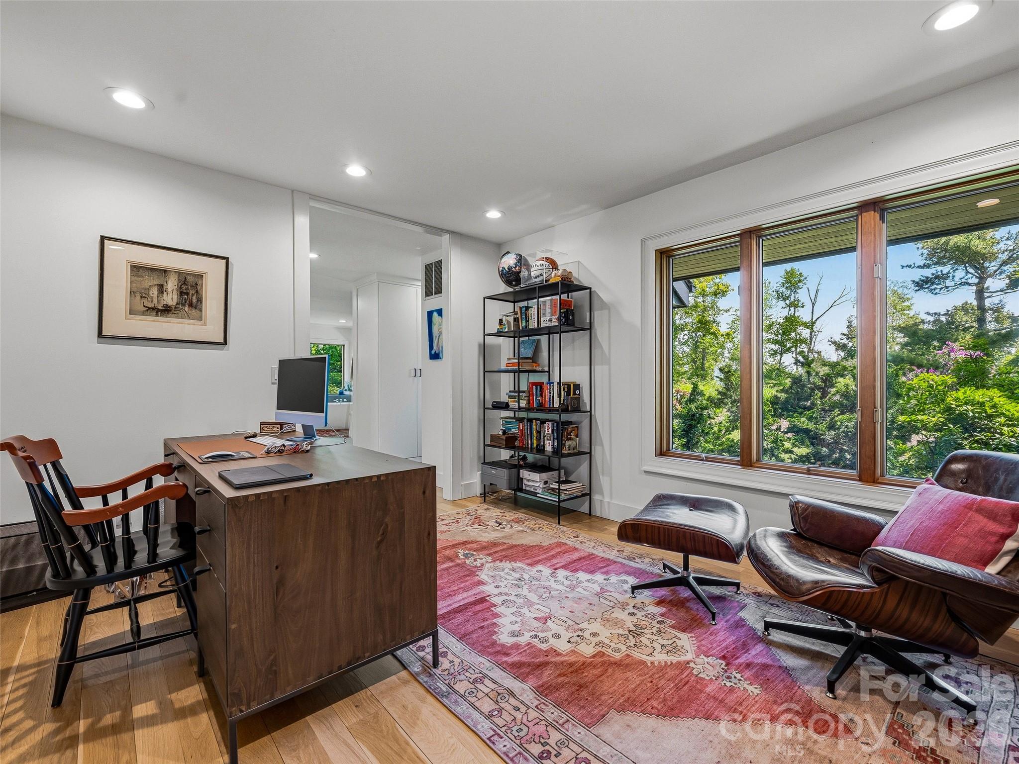 The primary suite includes an open concept flow into the home office. - 100 Big Spring Drive, Asheville