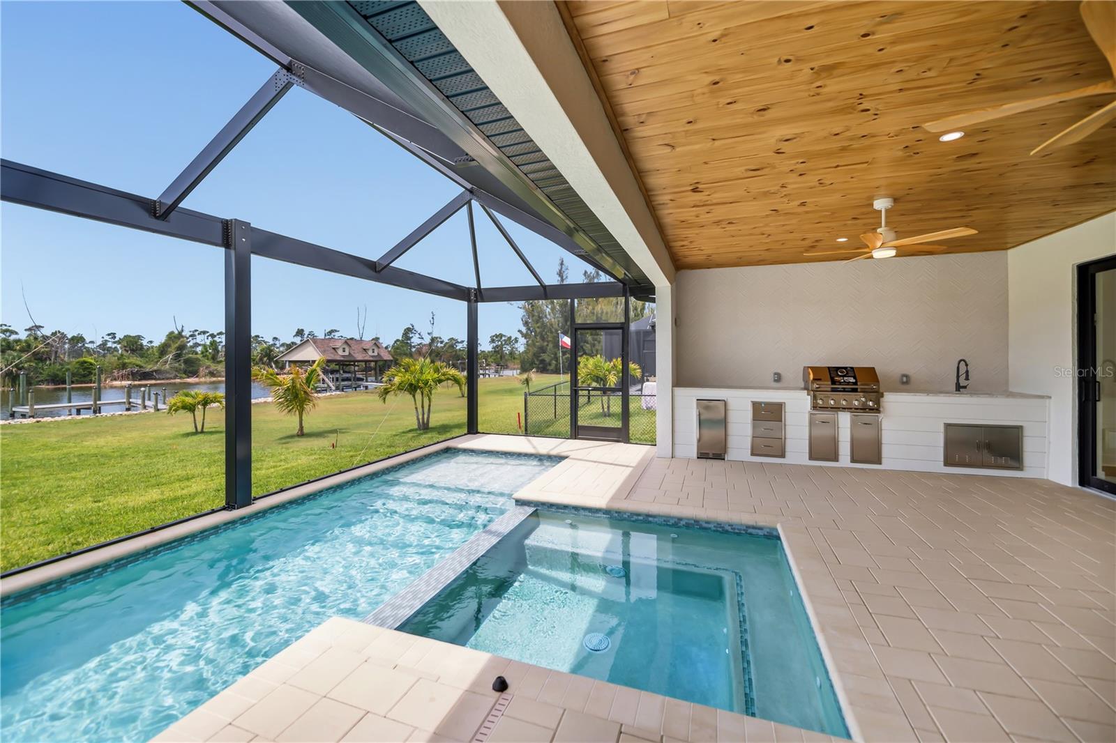Expansive Screened Pool Overlooking Water Views. - 16692 LIGGETT CIR, PORT CHARLOTTE
