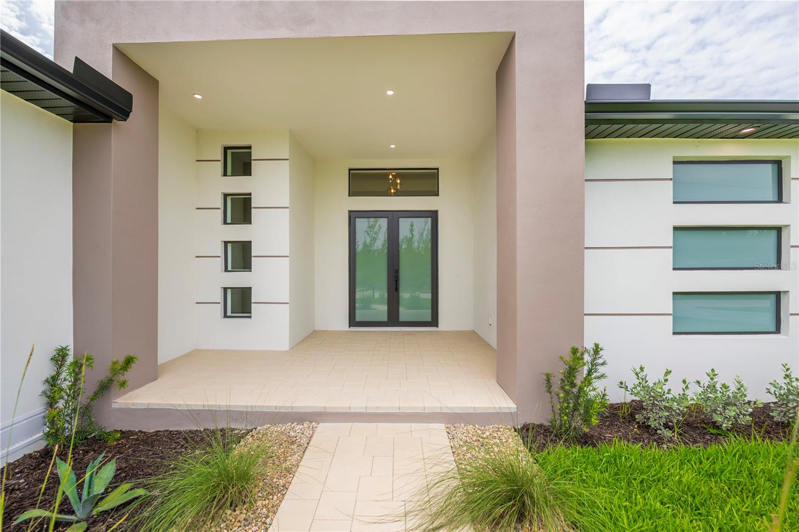 Grand Covered Entry with Soaring Ceilings and Custom Double Doors. - 16692 LIGGETT CIR, PORT CHARLOTTE
