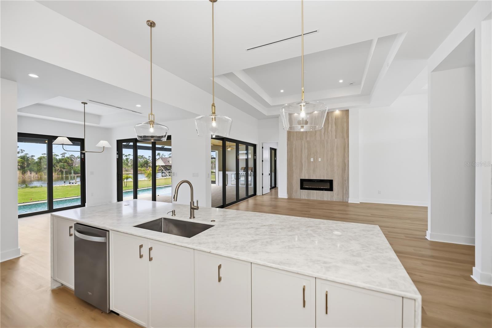 Gourmet Kitchen with Oversized Quartz Waterfall Island. - 16692 LIGGETT CIR, PORT CHARLOTTE