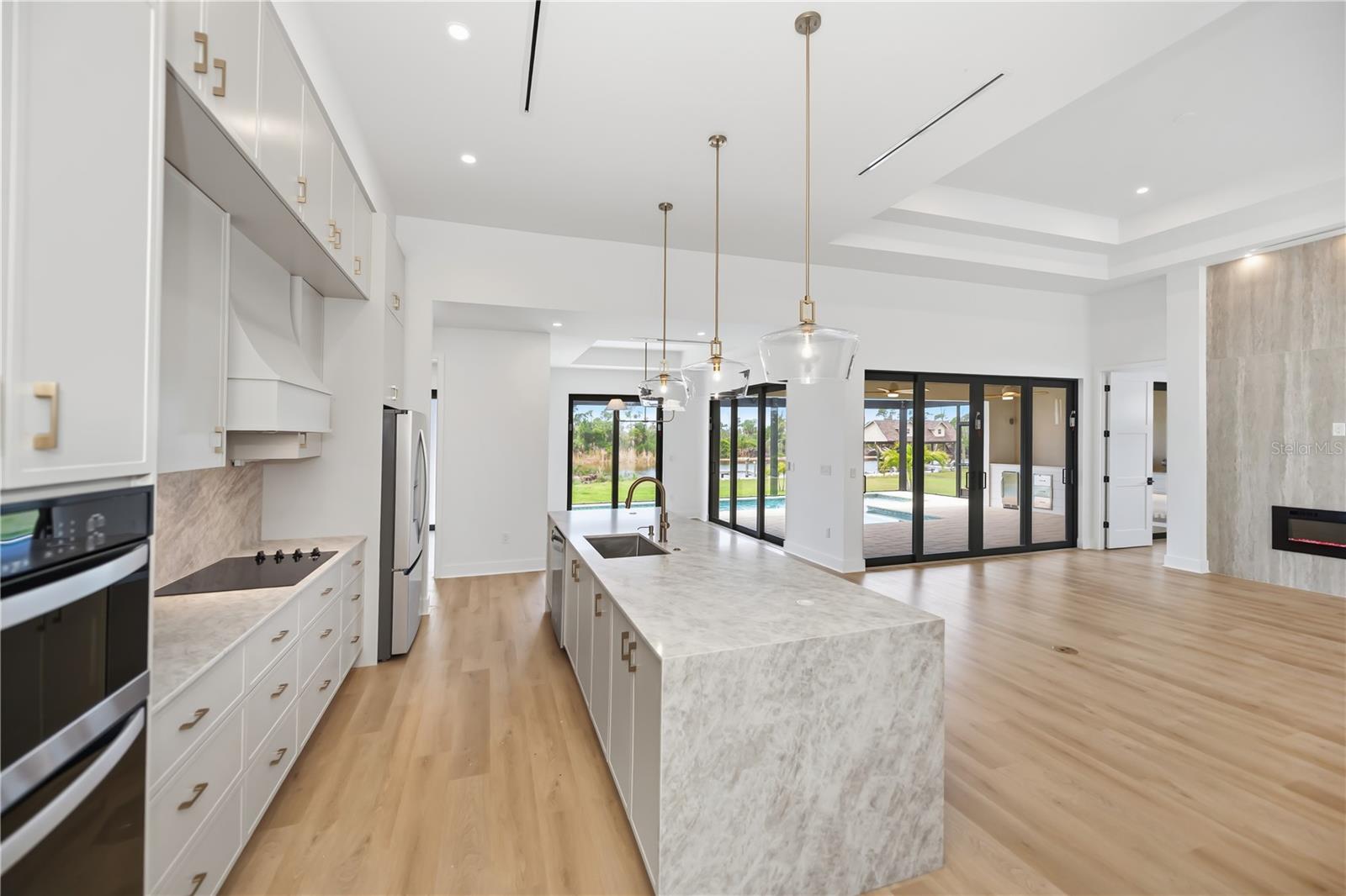 Kitchen Features Quartz Countertops, Waterfall Island, and Premium Appliances. - 16692 LIGGETT CIR, PORT CHARLOTTE