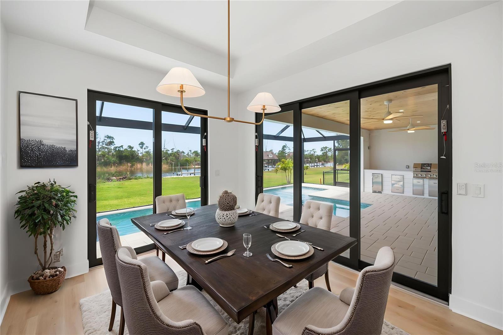 Virtually Staged Dining Area with Pool, Preserve and Water Views. - 16692 LIGGETT CIR, PORT CHARLOTTE