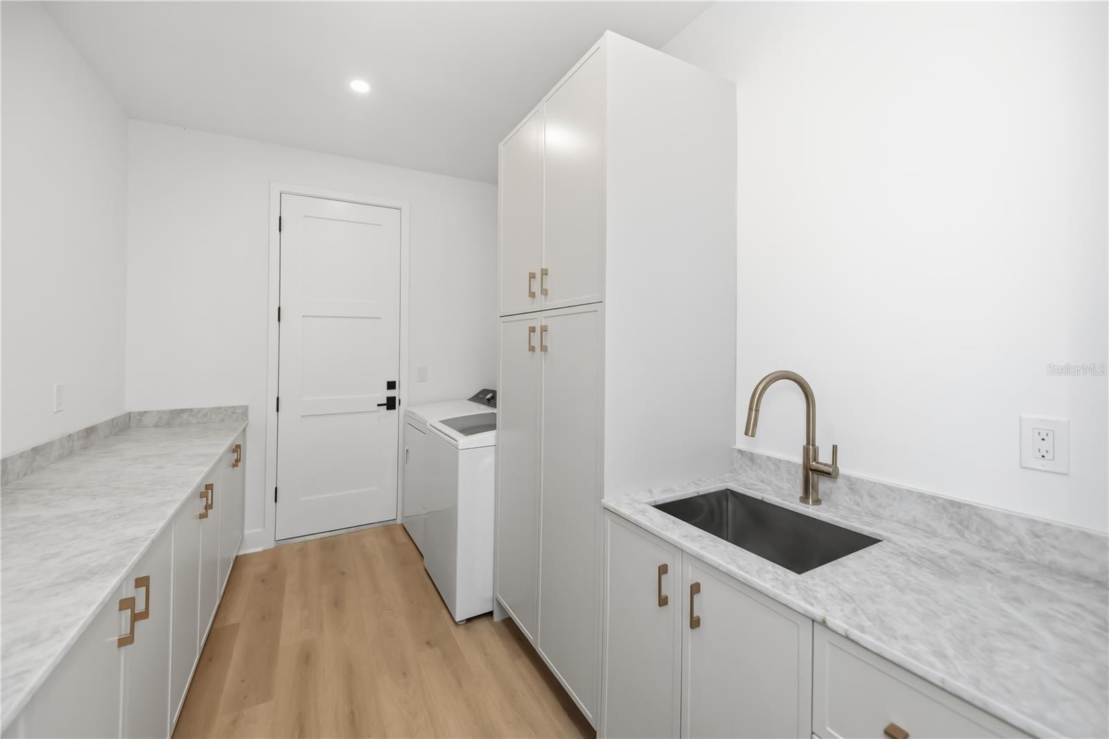 Spacious Laundry Room with Utility Sink and Ample Storage. - 16692 LIGGETT CIR, PORT CHARLOTTE