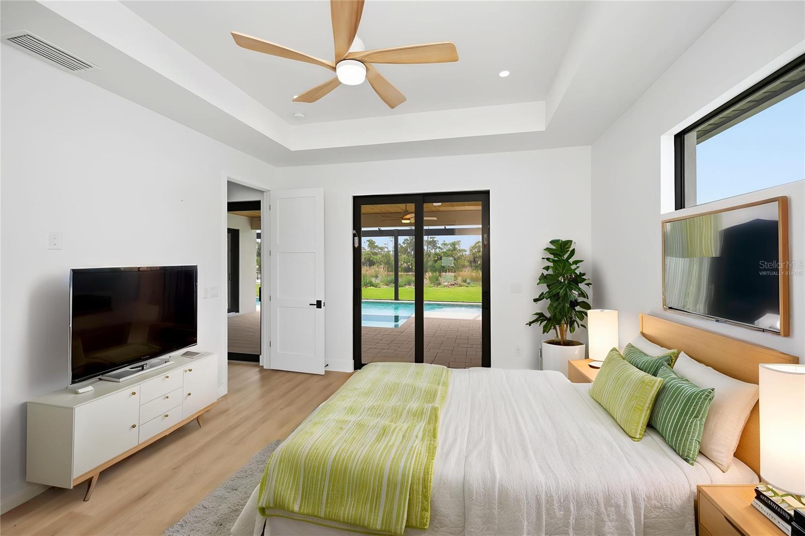 Virtually Staged Primary Suite with Pool Access and Serene Preserve Views. - 16692 LIGGETT CIR, PORT CHARLOTTE