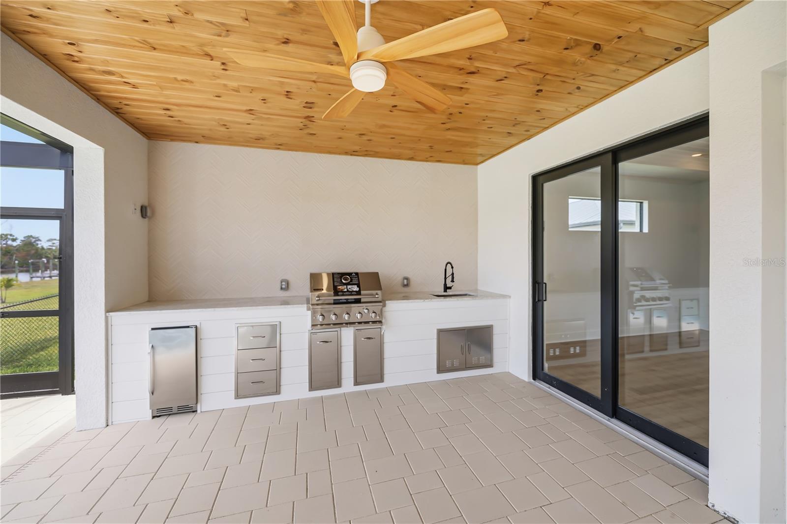 Outdoor Kitchen with Built-In Grill and Beverage Fridge. - 16692 LIGGETT CIR, PORT CHARLOTTE