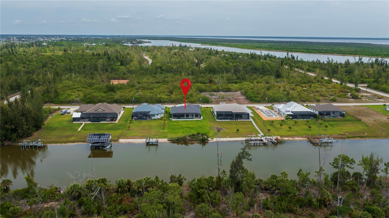 Aerial View Showcasing Waterfront Homesite with Preserve Backdrop. - 16692 LIGGETT CIR, PORT CHARLOTTE