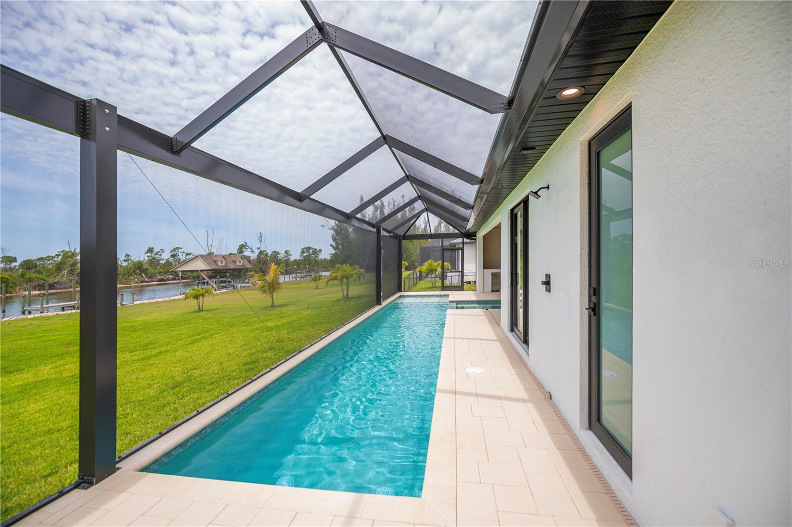 Expansive Screened Pool Overlooking Water Views. - 16692 LIGGETT CIR, PORT CHARLOTTE